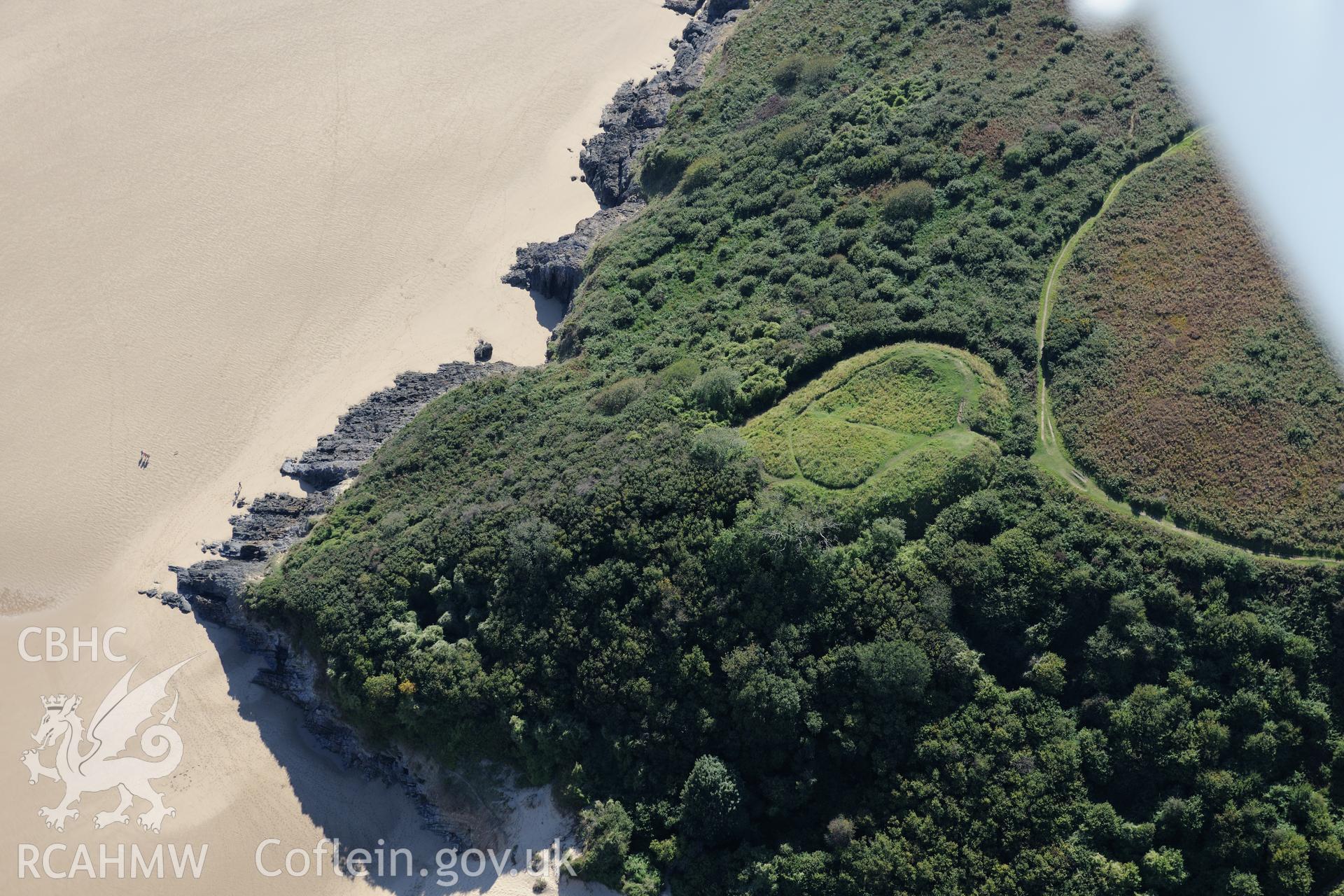 Castle Tower at Three Cliffs Bay, on the southern coast of the Gower Peninsula. Oblique aerial photograph taken during the Royal Commission's programme of archaeological aerial reconnaissance by Toby Driver on 30th September 2015.
