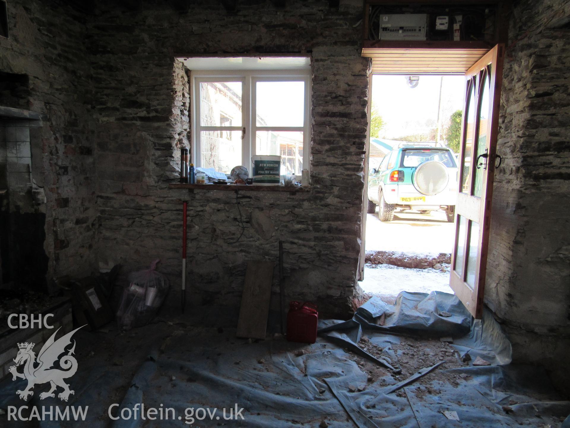 Kitchen in original house with modern inserted entrance doorway, view north-east. Photographed as part of archaeological building recording conducted at Bryn Ysguboriau, Llanelidan, Denbighshire, carried out by Archaeology Wales, 2018. Project no. P2587.