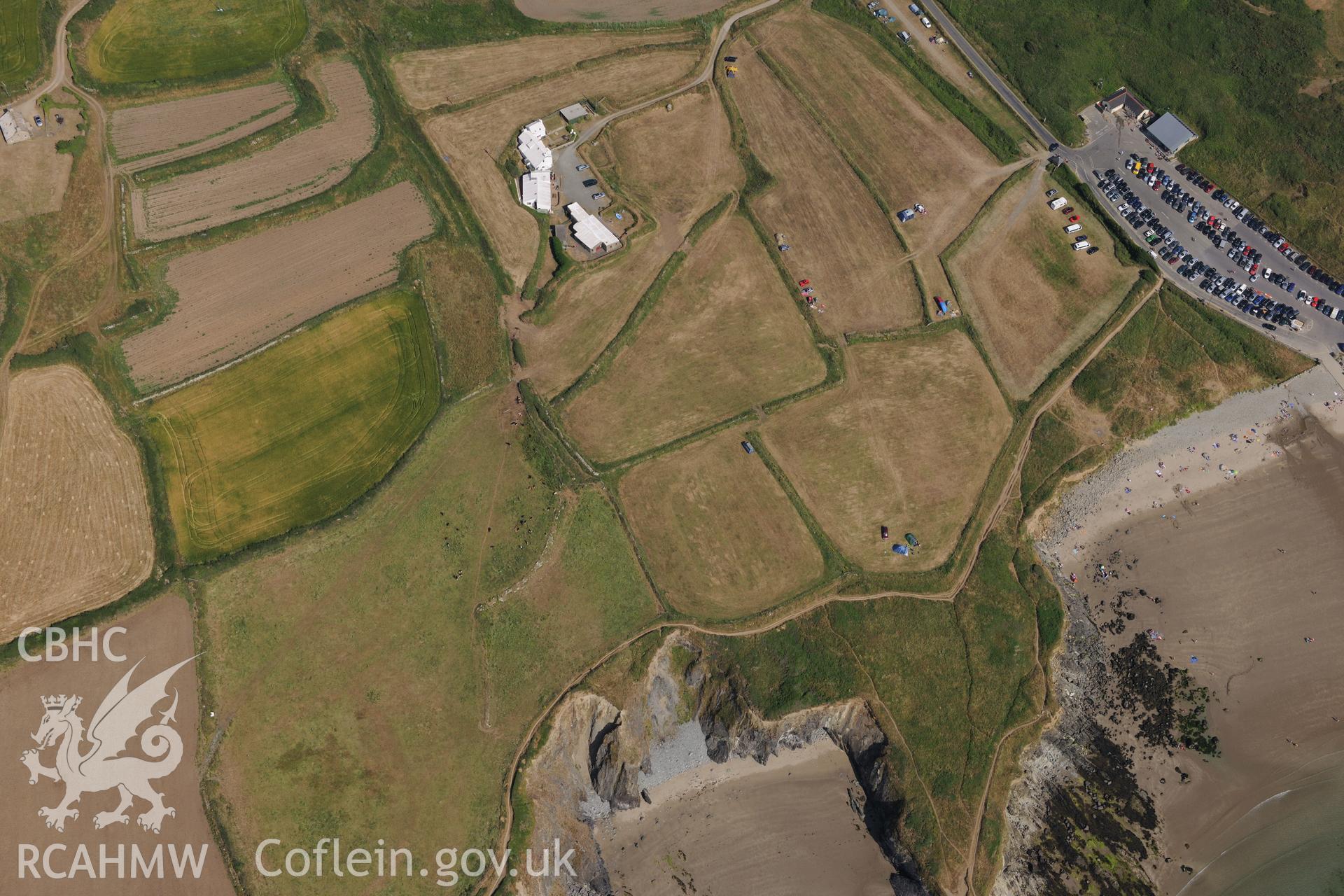 The site of St Patrick's chapel on Whitesands Bay, north west of St Davids. Oblique aerial photograph taken during the Royal Commission?s programme of archaeological aerial reconnaissance by Toby Driver on 16th July 2013.