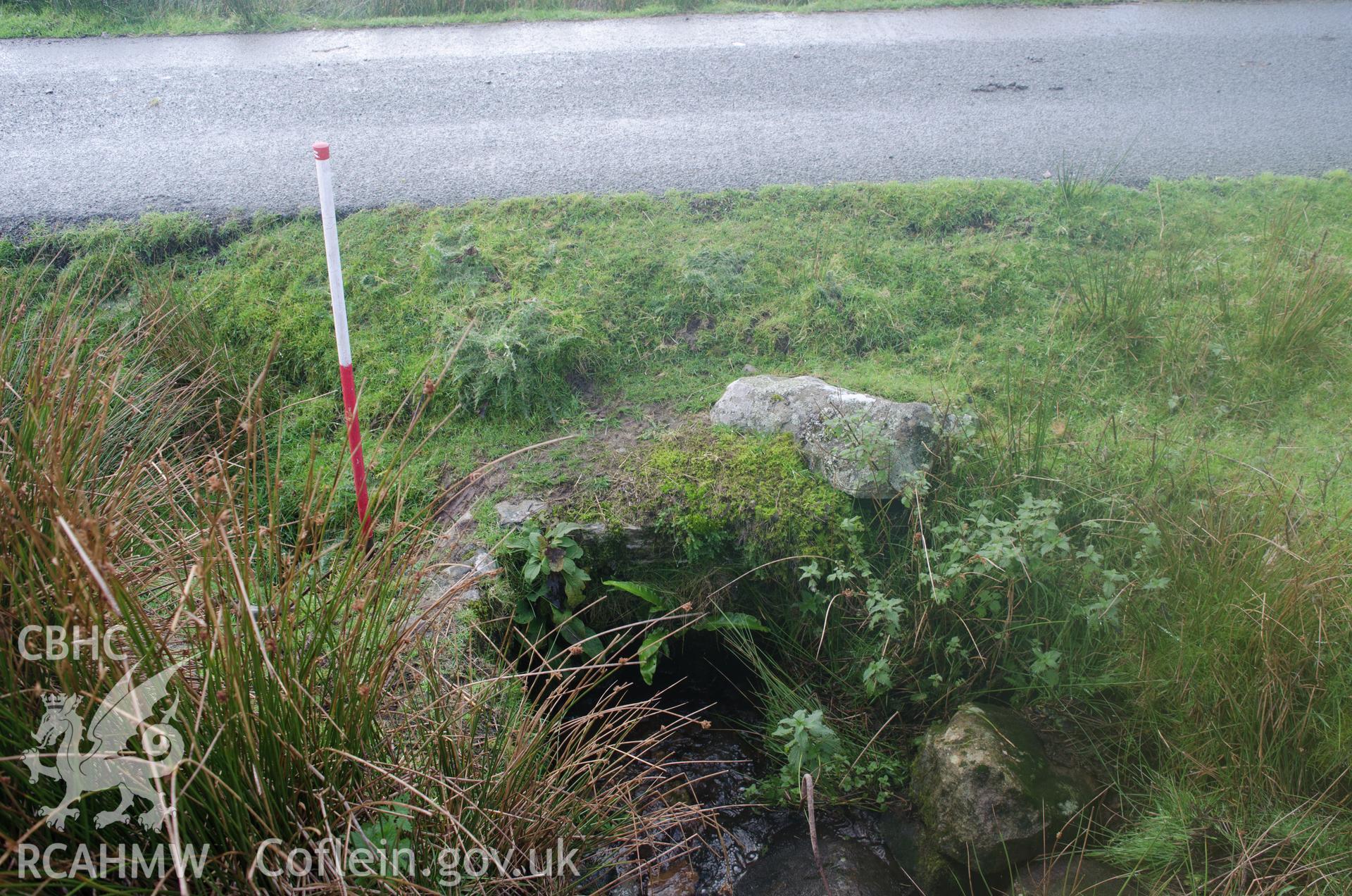 View from the south of a culvert under the road on the downstream end at Llyn Gelli-Gain reservoir, Trawsfynydd. Photographed as part of archaeological assessment conducted by Gwynedd Archaeological Trust on 16th October 2018. Project no. 2579.