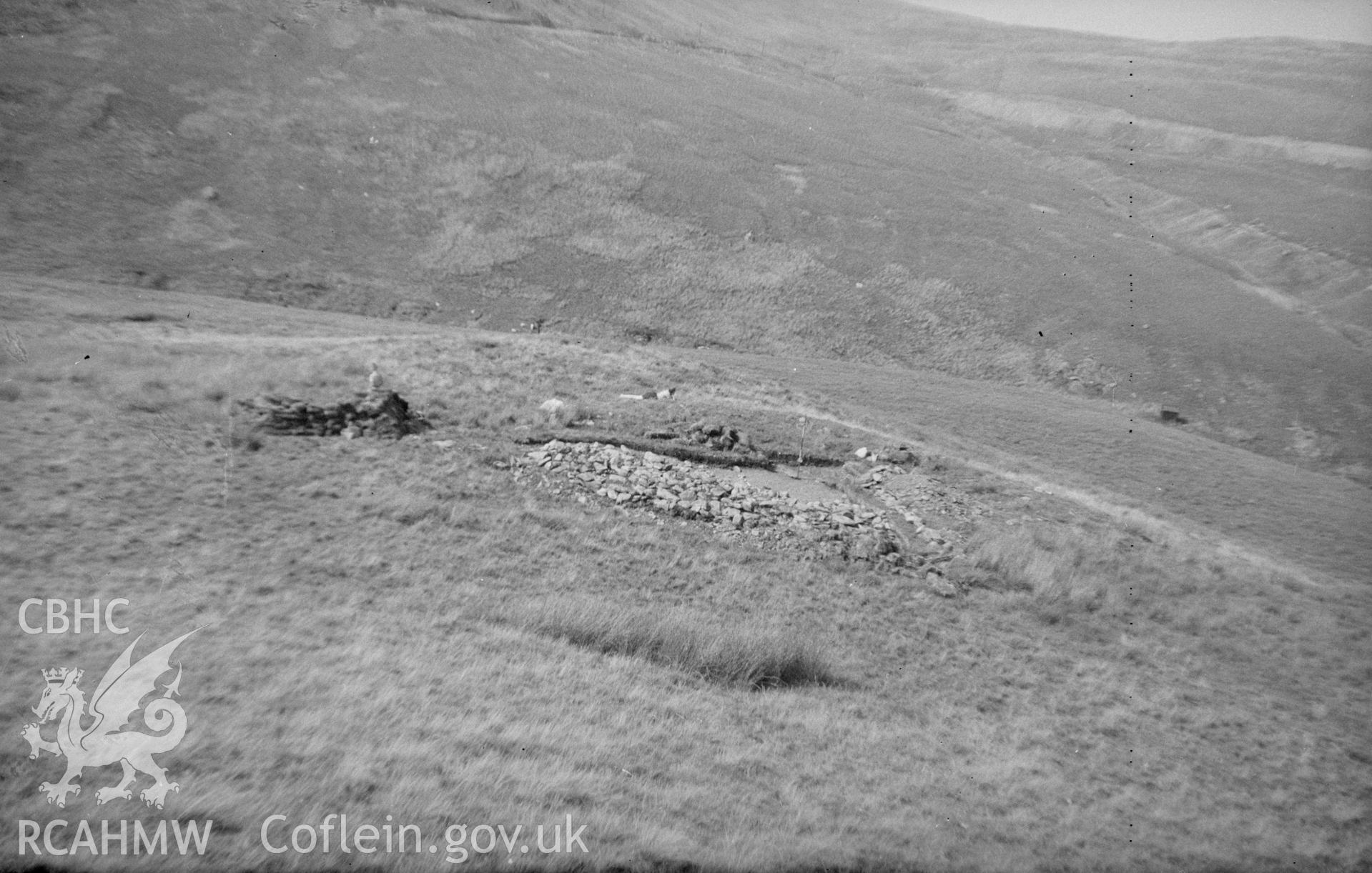 Digital copy of a black and white nitrate negative showing view of the remains of a stove site in a field, unknown location.