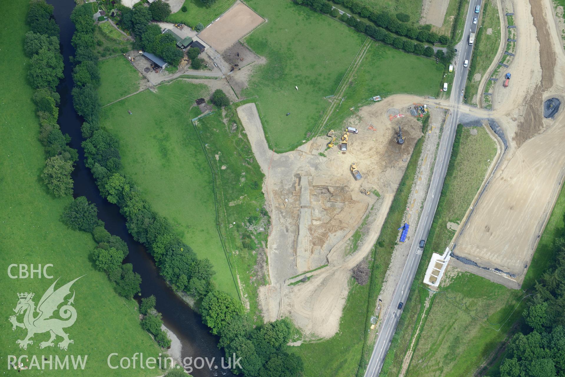 Royal Commission aerial reconnaissance of the construction of the Newtown Bypass. View near Glanhafren Hall (SO 083 902) with excavation of Roman road in progress