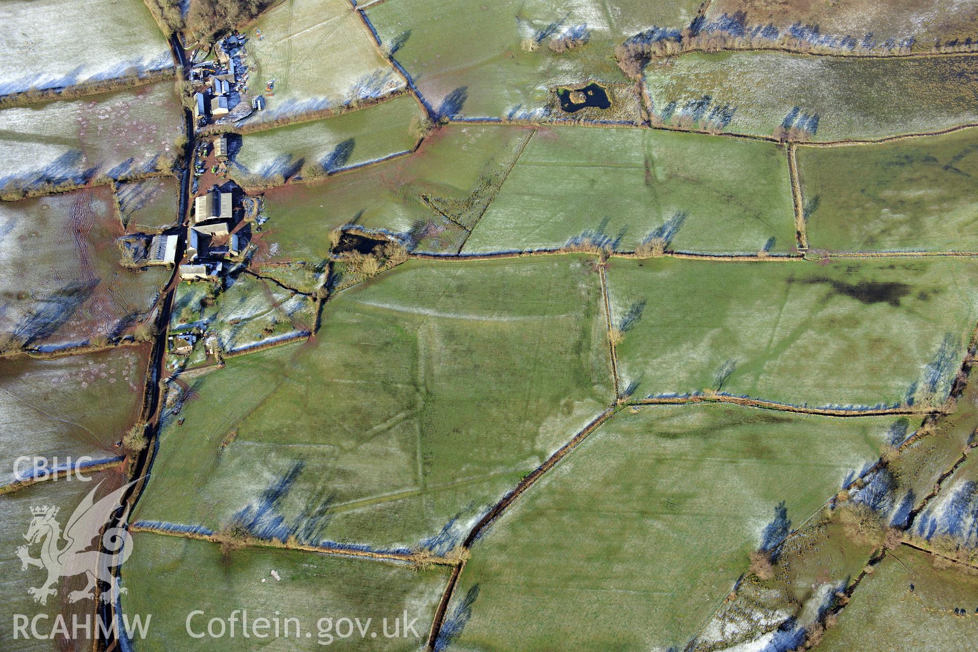 The village of Llangasty-Talyllyn and surrounding fields, south east of Brecon. Oblique aerial photograph taken during the Royal Commission?s programme of archaeological aerial reconnaissance by Toby Driver on 15th January 2013.