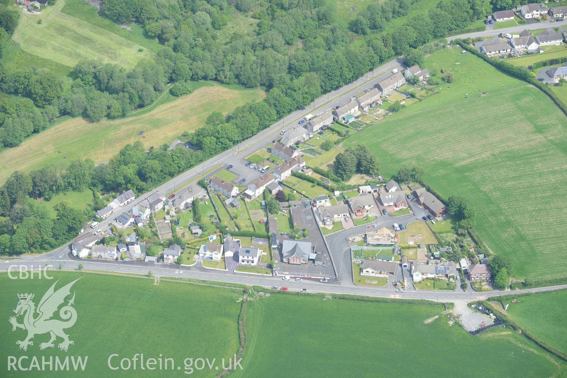 Housing and the village school at Meidrim, Carmarthenshire. Oblique aerial photograph taken during the Royal Commission's programme of archaeological aerial reconnaissance by Toby Driver on 11th June 2015.