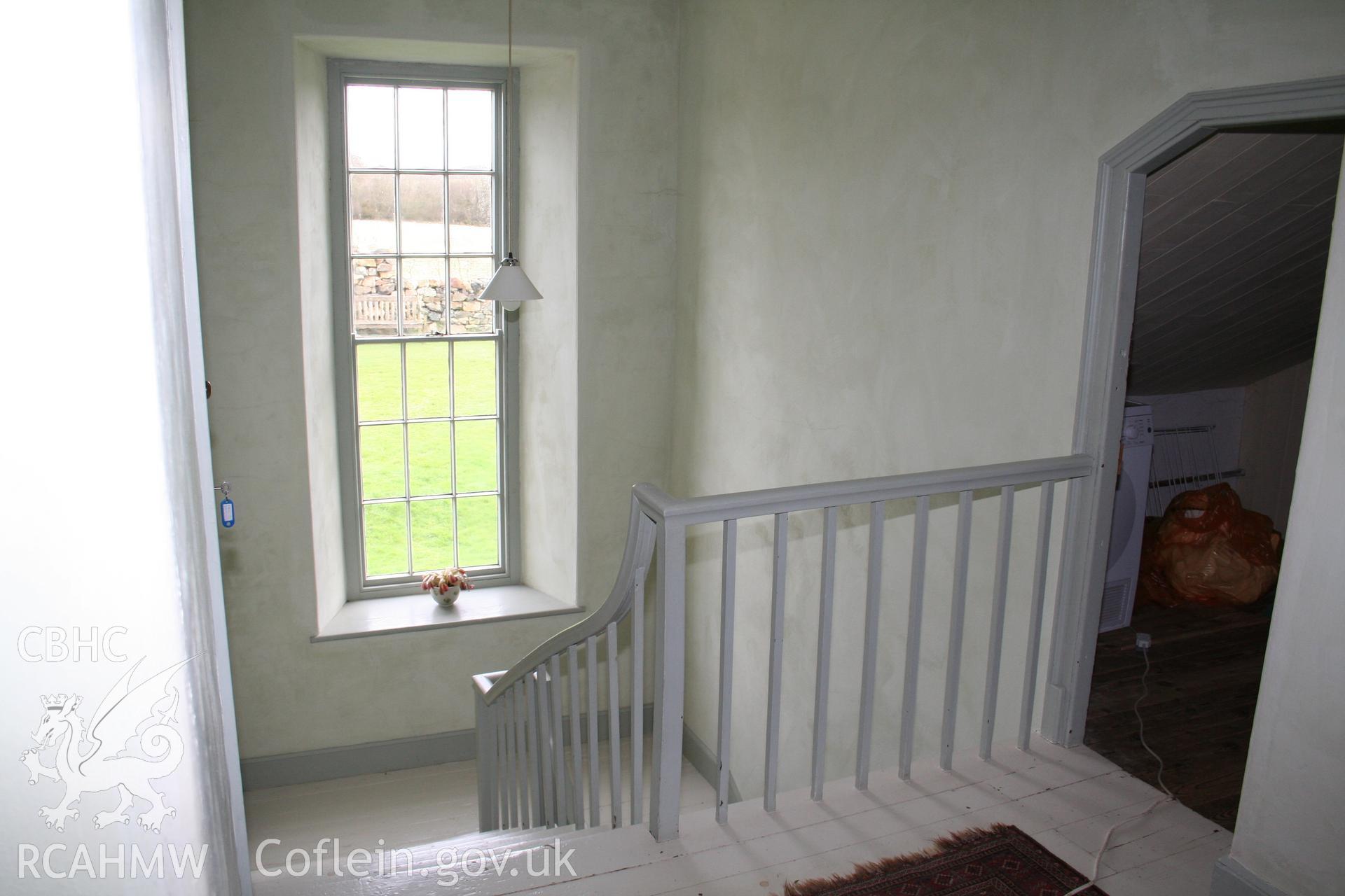 Interior view of Trehilyn Farmhouse including wooden floorboards, staircase and stair railings. Photographic survey of Trehilyn Farmhouse conducted by Geoff Ward in 2011.