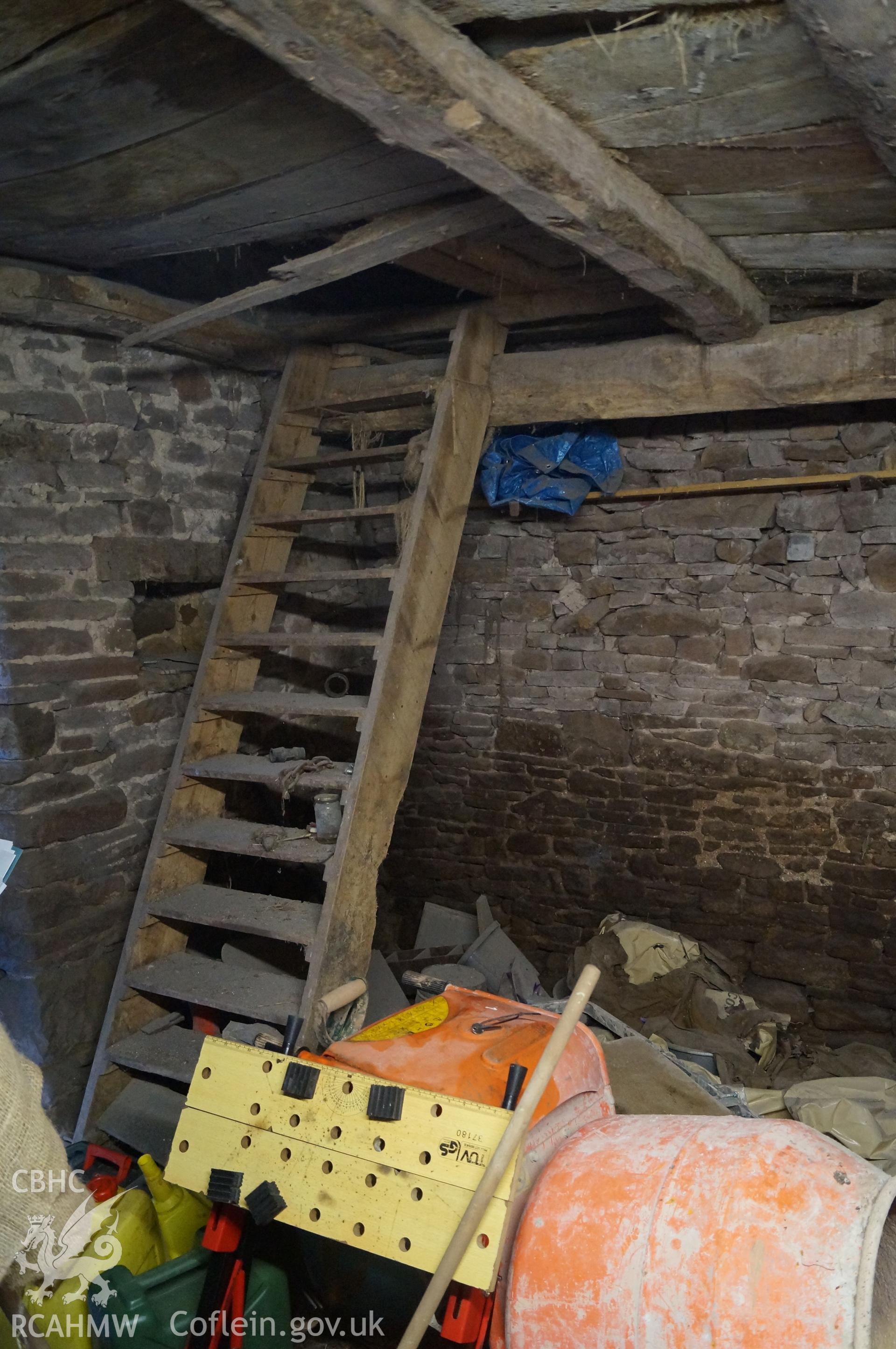 Interior view 'looking south southeast to the south southeast corner of the stables, showing steps to the loft and small niche behind, and Beam D' on Gwrlodau Farm. Photograph and description by Jenny Hall and Paul Sambrook of Trysor, 9th Feb 2018.