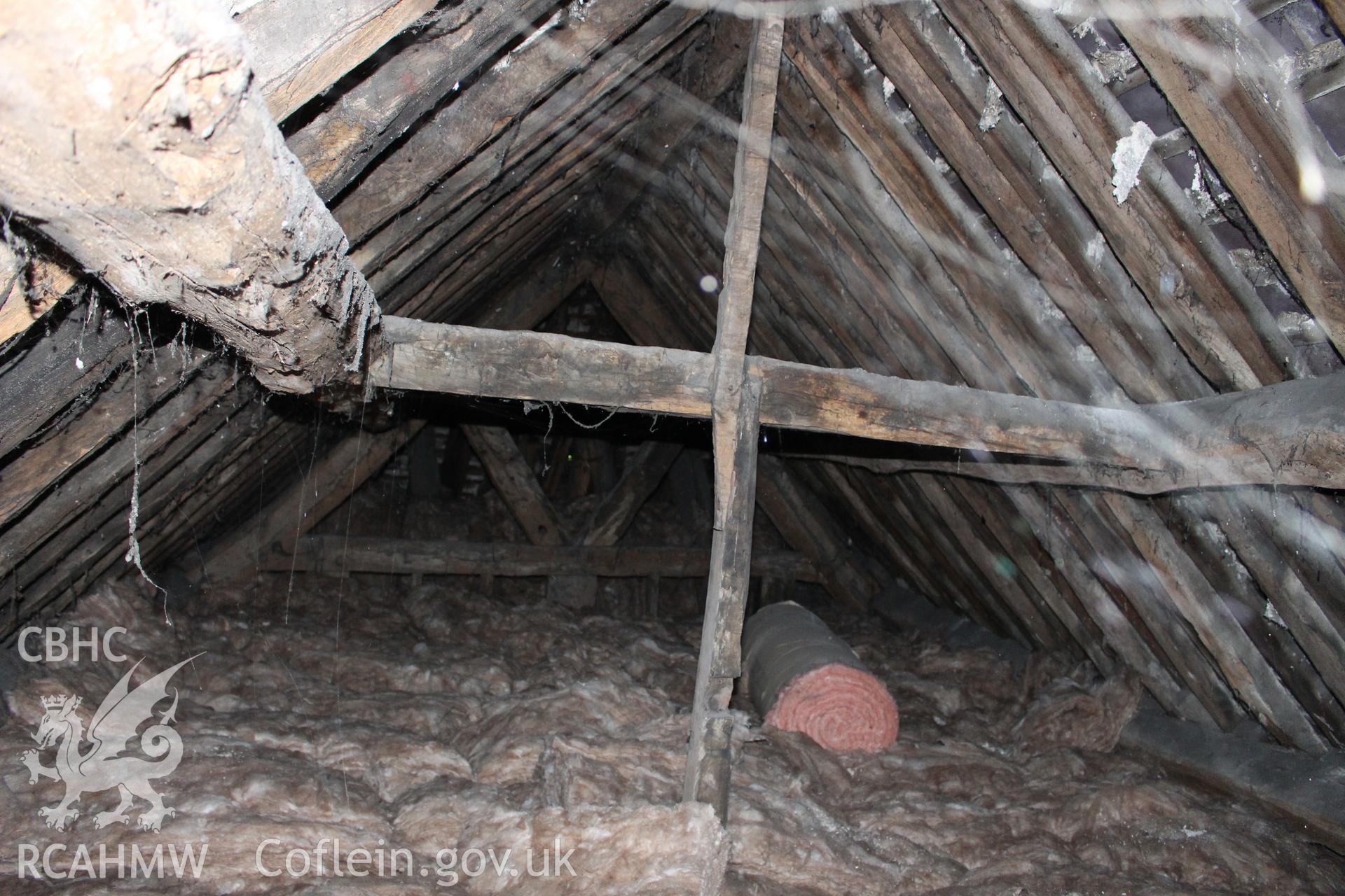 Colour photograph showing detail of insulating wool and timber roof frame at 5-7 Mwrog Street, Ruthin. Photographed during survey conducted by Geoff Ward on 14th May 2014.