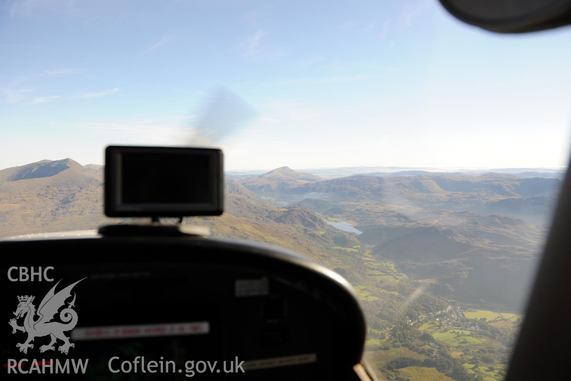 Beddgelert, at the foot of Moel Hebog in the Glaslyn valley, with Moel y Dyniewyd and Snowdon beyond. Oblique aerial photograph taken during the Royal Commission's programme of archaeological aerial reconnaissance by Toby Driver on 2nd October 2015.