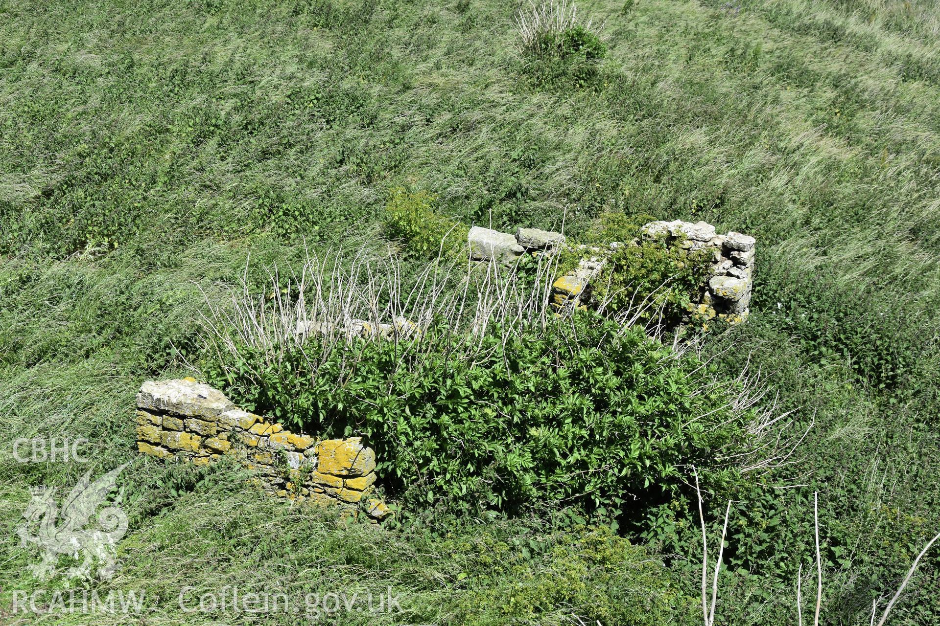 Investigator's photographic survey of the Telegraph Station on Puffin Island or Ynys Seiriol for the CHERISH Project. View of low stone structure set 10m away to the north-east of the main telegraph station. ? Crown: CHERISH PROJECT 2018. Produced with EU funds through the Ireland Wales Co-operation Programme 2014-2020. All material made freely available through the Open Government Licence.