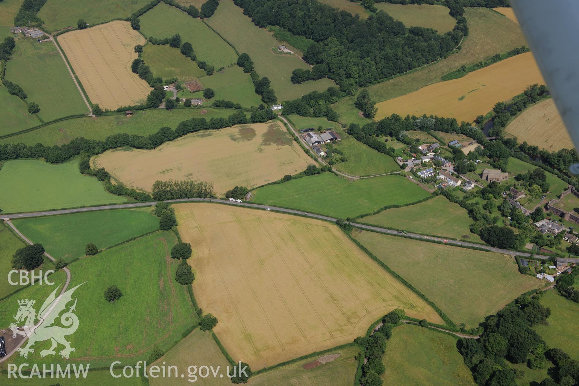 Cropmark just to the west of Skenfrith, north west of Monmouth. Oblique aerial photograph taken during the Royal Commission?s programme of archaeological aerial reconnaissance by Toby Driver on the 1st August 2013.