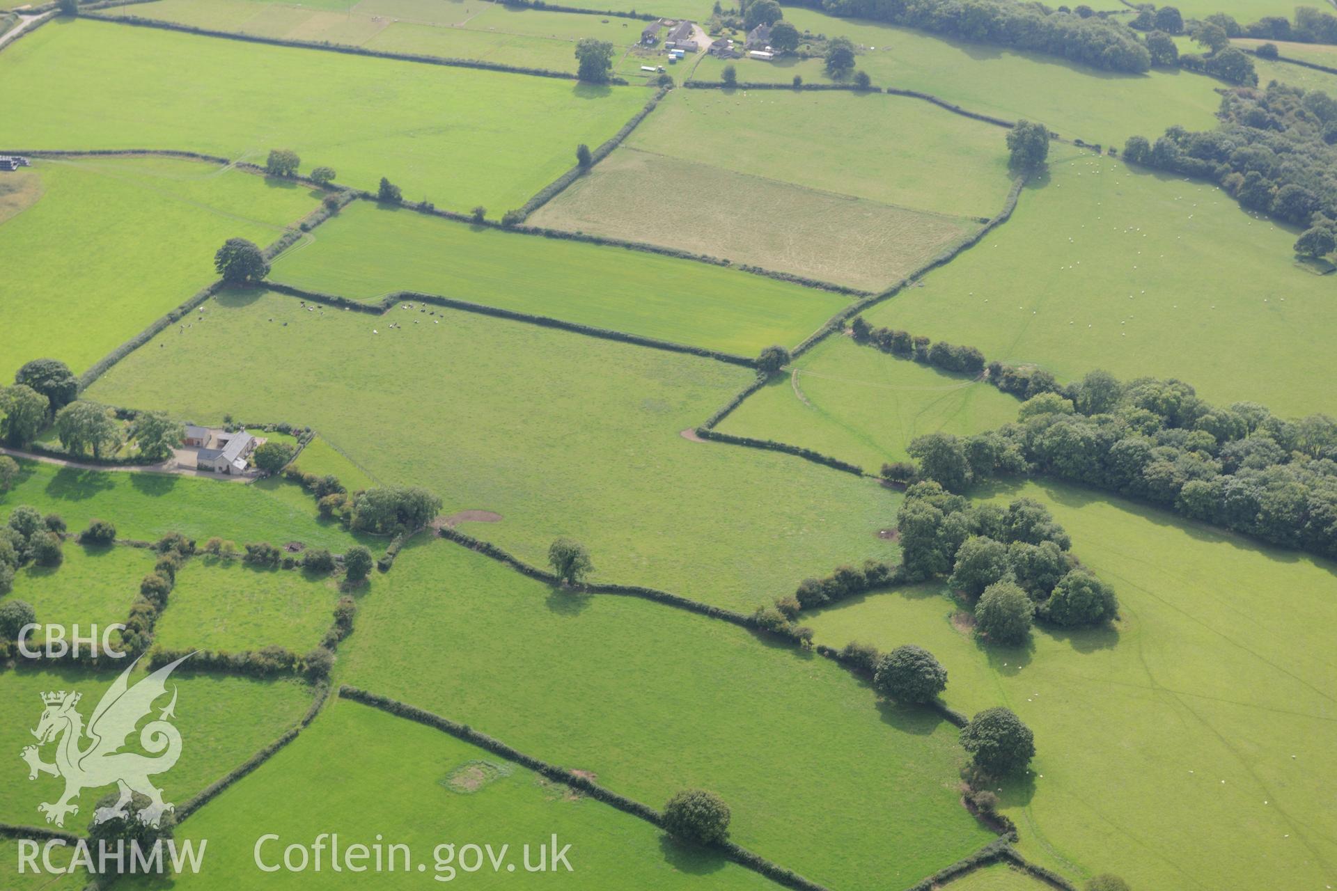 Bryn Sion farm, Caerwys, with the farmhouse in the distance. Oblique aerial photograph taken during the Royal Commission's programme of archaeological aerial reconnaissance by Toby Driver on 11th September 2015.