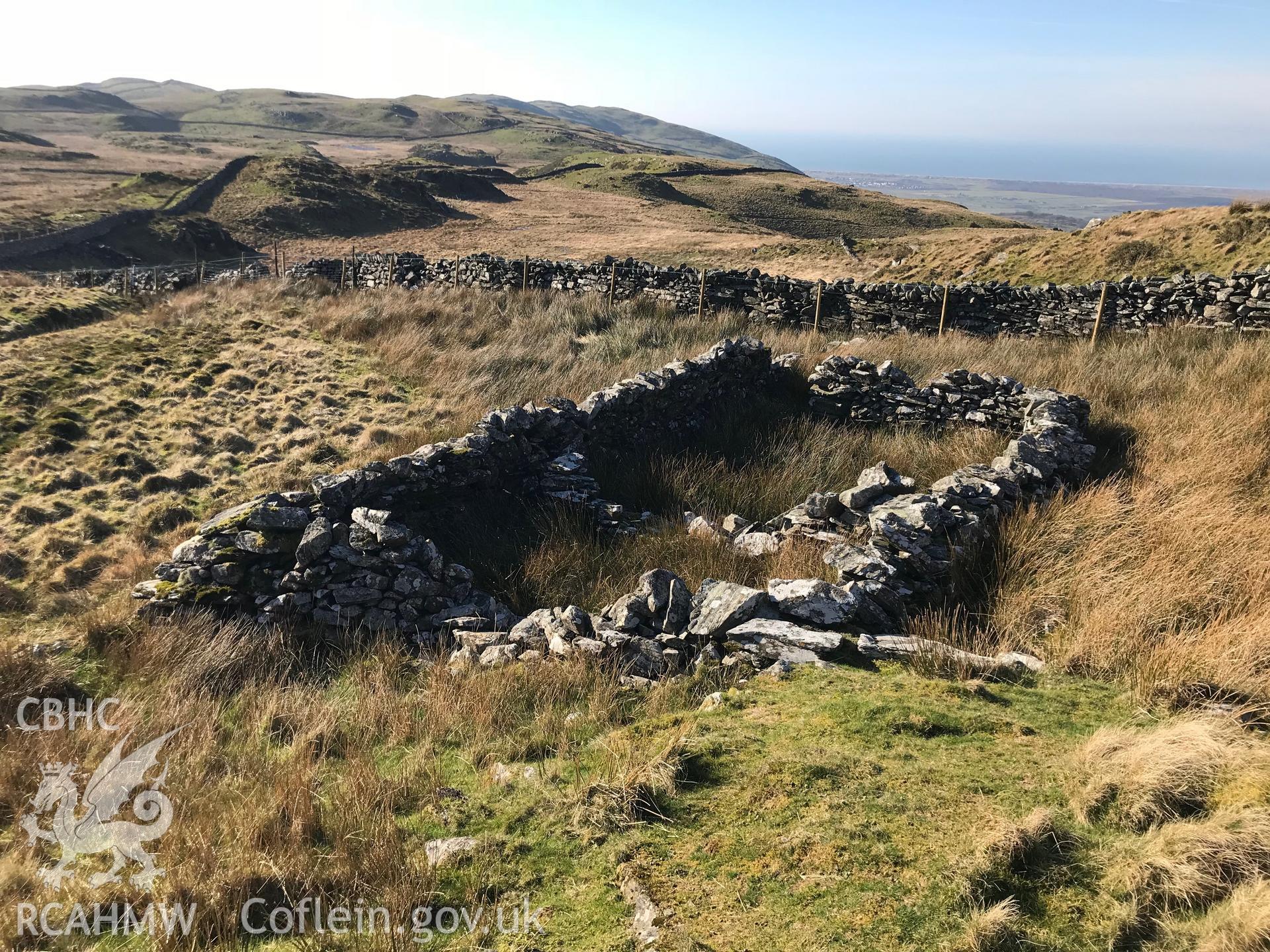 Digital colour photograph of rectangular drystone ruins at Moel-y-Geifr, Talsarnau, taken by Paul R. Davis on 15th February 2019.