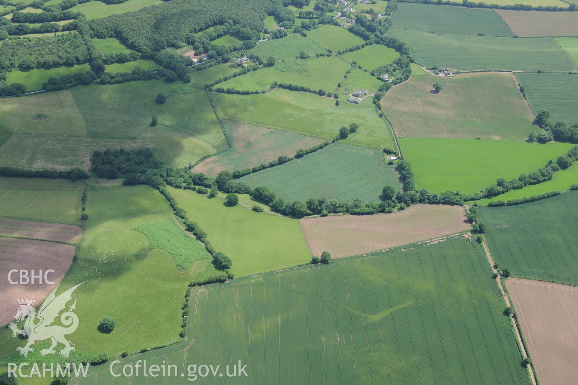 Ffynnon Gaer Hillfort and possible trackway measuring 200m running south west from the hillfort. Oblique aerial photograph taken during the Royal Commission's programme of archaeological aerial reconnaissance by Toby Driver on 29th June 2015.