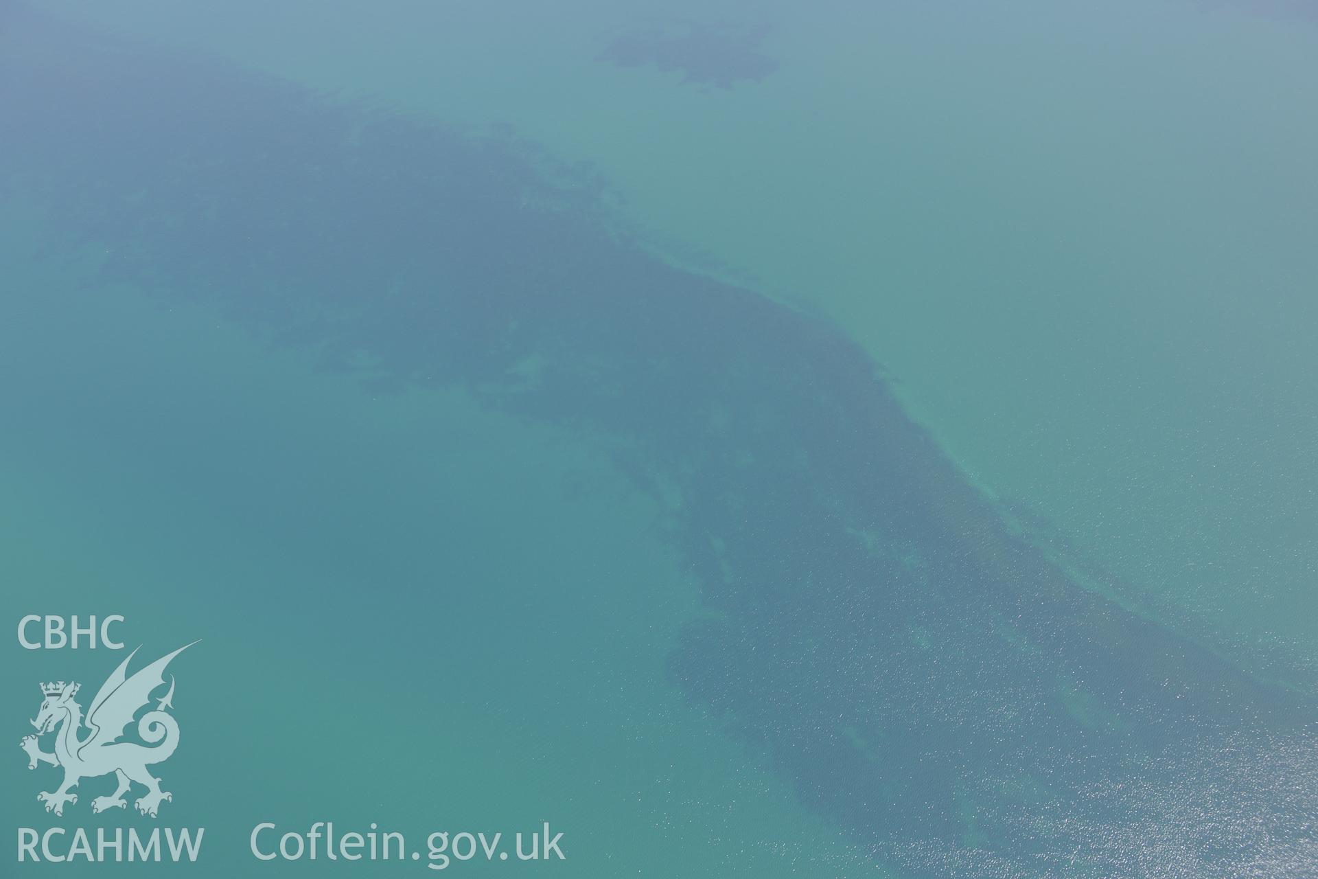Sarn Padrig Reef, off the coast of Llaneddwyn, Dyffryn Ardudwy, Gwynedd. Oblique aerial photograph taken during the Royal Commission?s programme of archaeological aerial reconnaissance by Toby Driver on 12th July 2013.