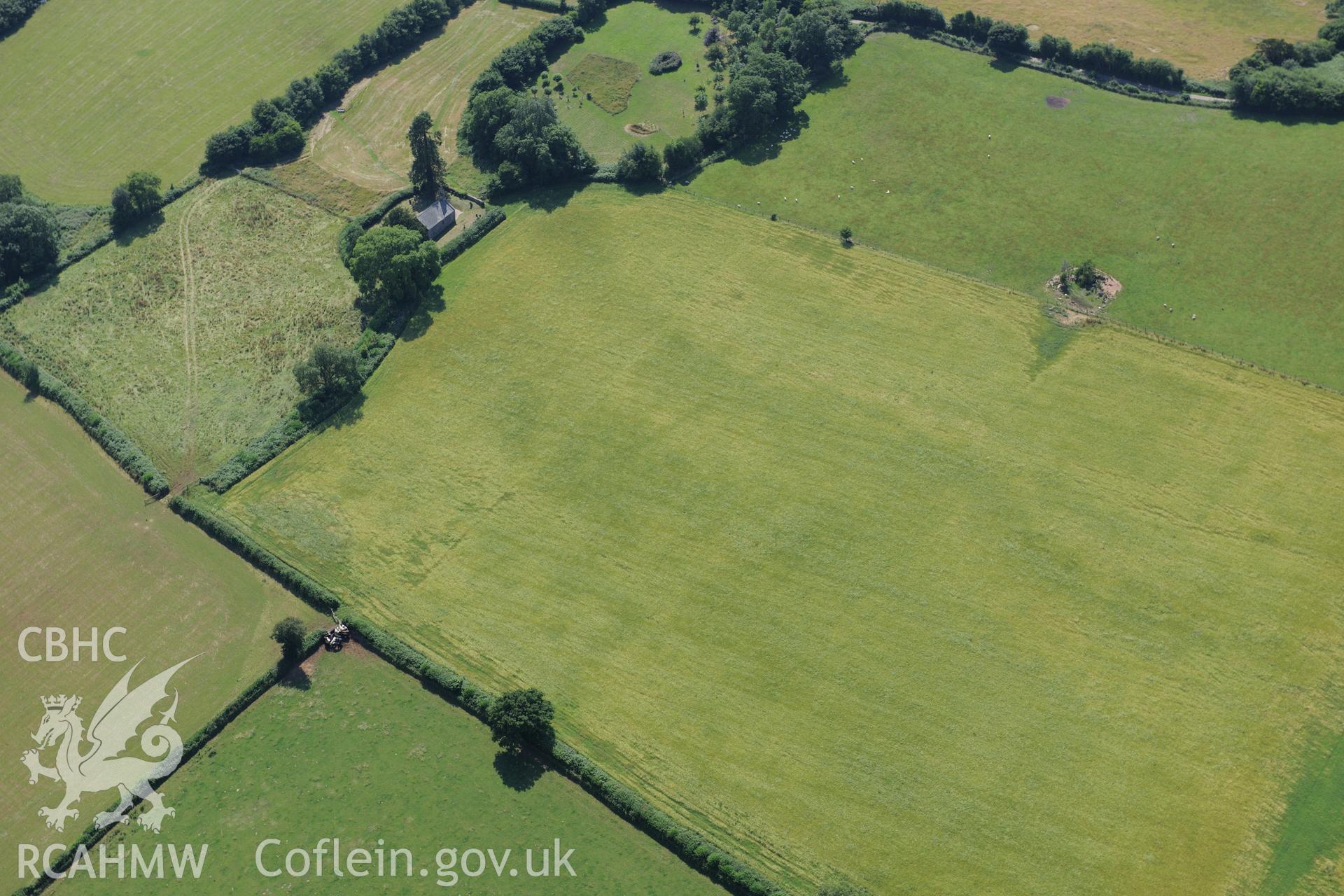 St. Mary's church, Penterry, near Tintern, and a prehistoric defended enclosure in the field immediately to its north. Oblique aerial photograph taken during the Royal Commission?s programme of archaeological aerial reconnaissance by Toby Driver on 1st August 2013.