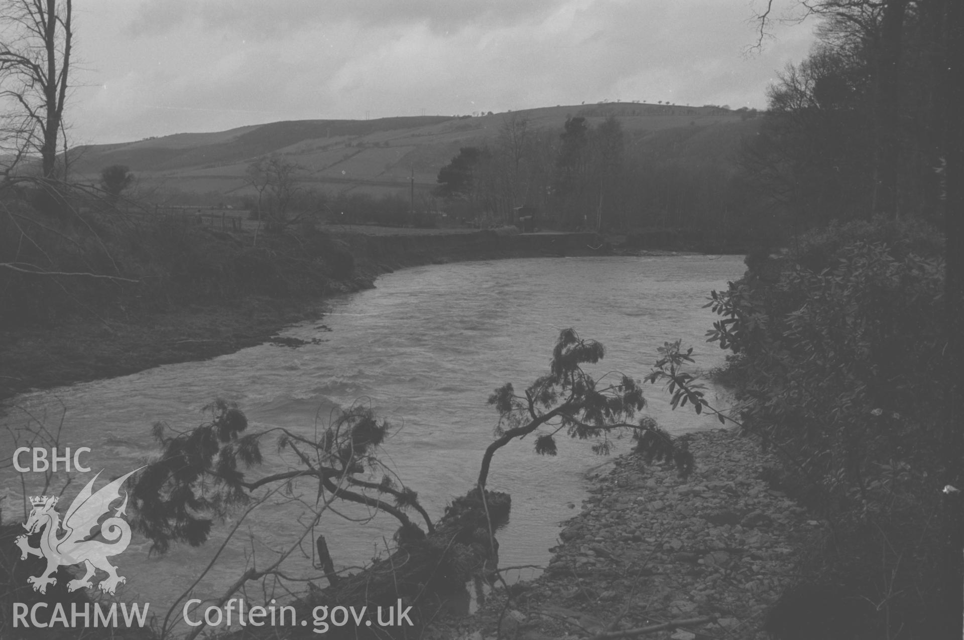 Digital copy of a black and white negative showing flood damage by the Ystwyth opposite Trawscoed Lodge. Photographed by Arthur O. Chater in December 1964 from Grid Reference SN 6665 7311, looking north north west.