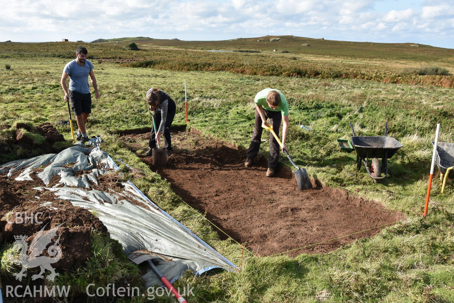 Investigator's photography showing the evaluation excavation of a geophysical anomaly in Well Meadow, Skomer Island, between 25-27th Sept 2018 as part of the Skomer Island Project. General view from east showing removal of topsoil.
