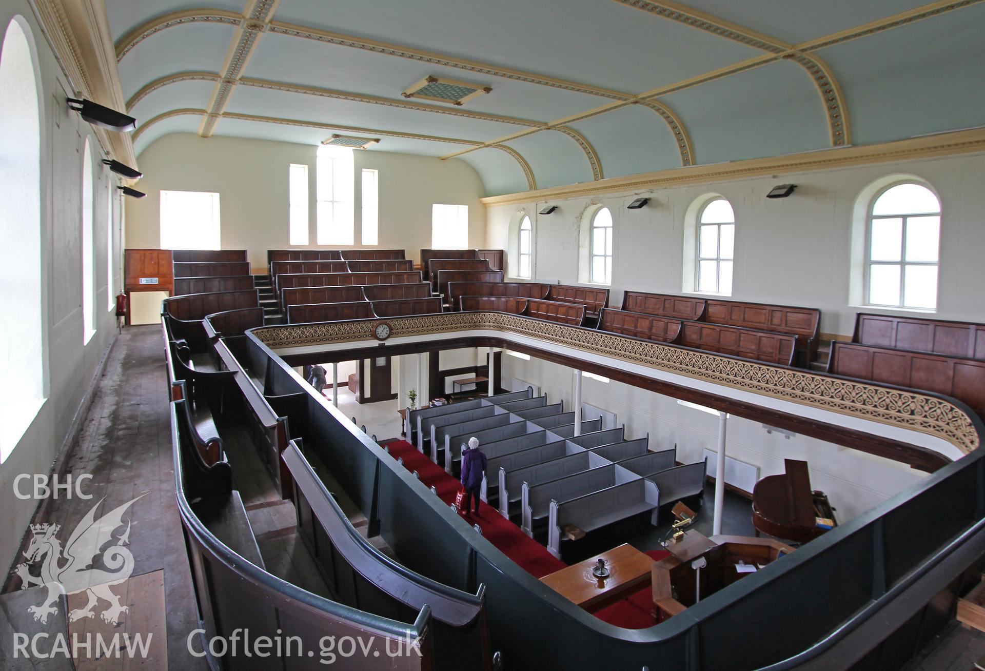 Colour photograph showing interior view looking from first floor balcony towards pews at Mynydd-Bach Independent Chapel, Treboeth, Swansea. Taken during photographic survey conducted by Sue Fielding on 13th May 2017.