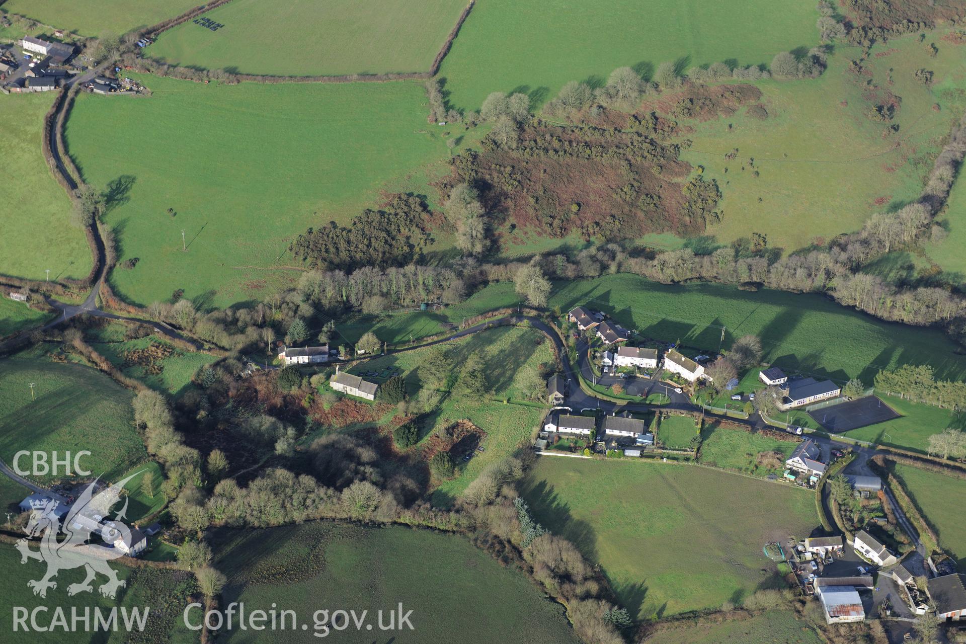 The village of Abernant, Carmarthenshire, with the church in the centre of the photograph and the primary school on the right of the photograph. Oblique aerial photograph taken during the Royal Commission?s programme of archaeological aerial reconnaissance by Toby Driver on 15th January 2013.