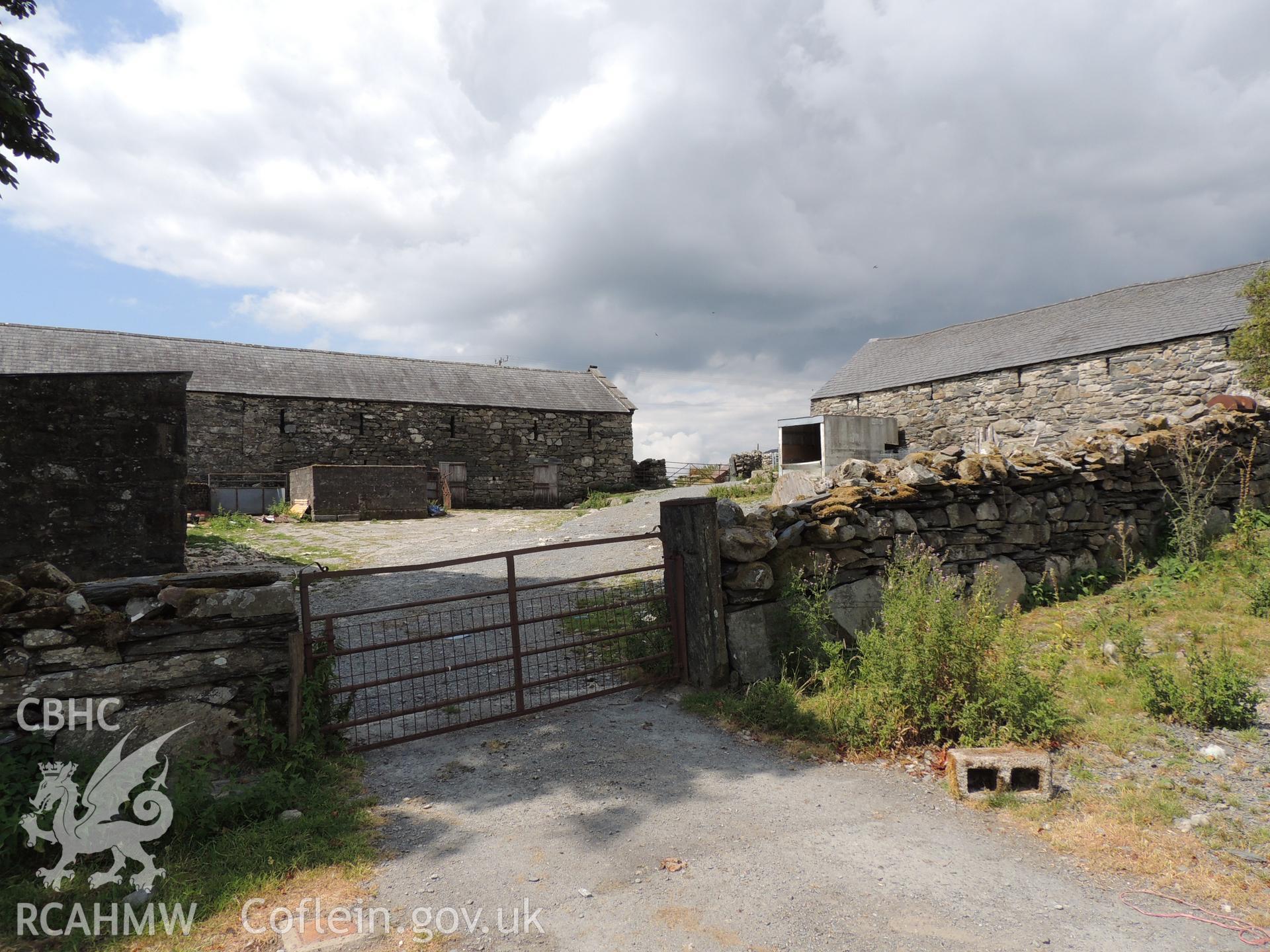 'View of Parc farmyard looking east north-east.' Photographed as part of desk based assessment and heritage impact assessment of a hydro scheme on the Afon Croesor, Brondanw Estate, Gwynedd. Produced by Archaeology Wales for Renewables First Ltd. 2018.