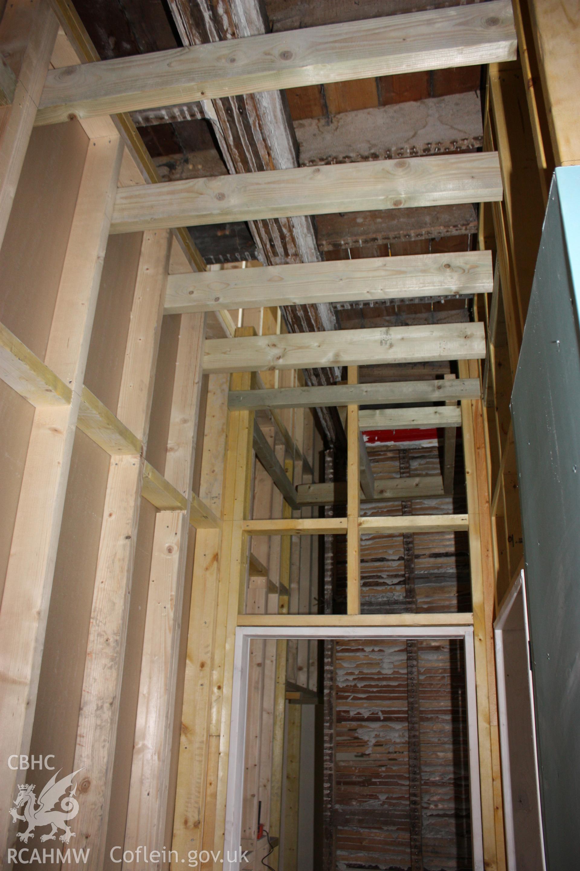 Colour photograph showing interior view of ceiling beam above first floor and lathe and plaster walls at the Old Auction Rooms/ Liberal Club in Aberystwyth. Photographic survey conducted by Geoff Ward on 9th June 2010 during repair work prior to conversion into flats.