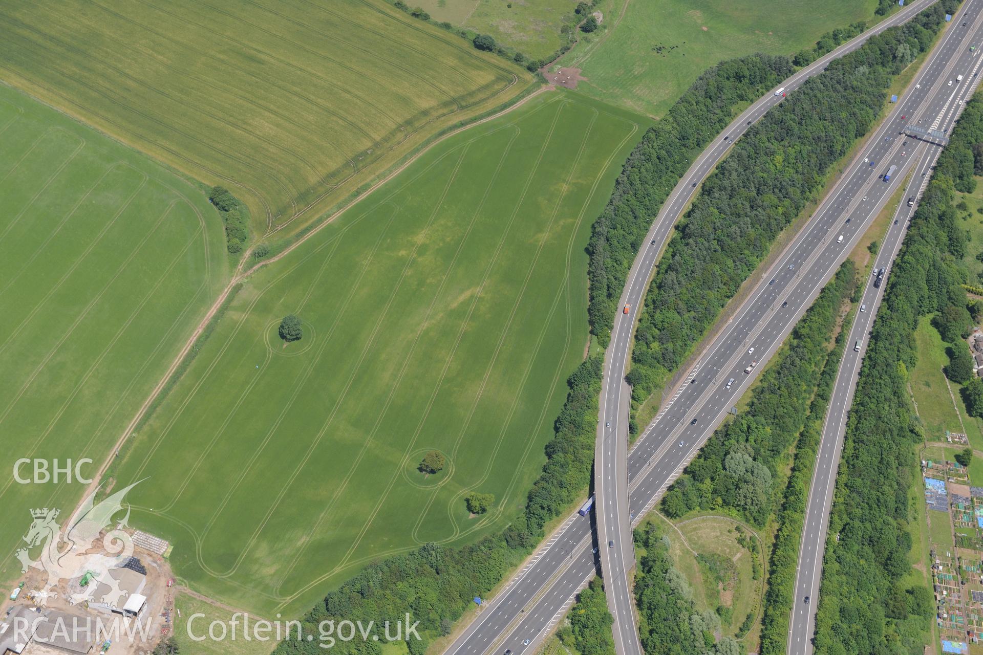 Cropmark enclosure east of New Park, near Junction 29 of the M4, Castleton. Oblique aerial photograph taken during the Royal Commission's programme of archaeological aerial reconnaissance by Toby Driver on 29th June 2015.