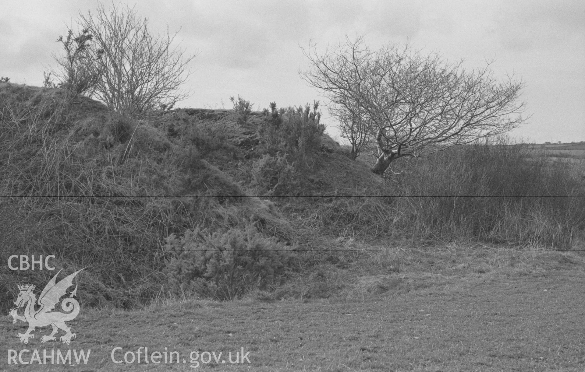Digital copy of a black and white negative showing the Norman motte 100m north east of the site of St Mary's church, Llanfair Trefhelygen. Photographed in April 1963 by Arthur O. Chater from Grid Reference SN 3444 4421, looking north west.
