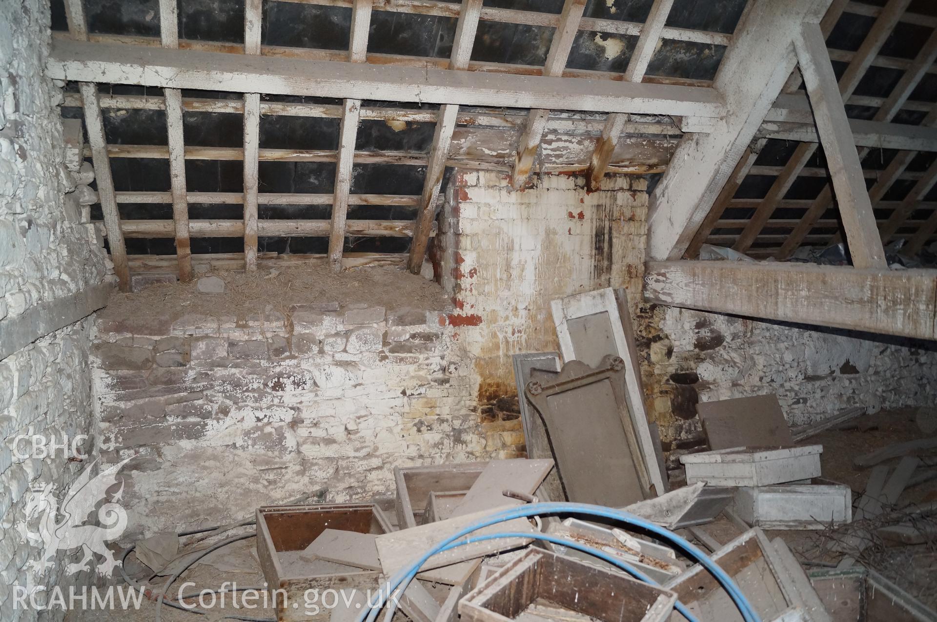 Internal view 'looking northwest at the stable loft showing the brick chimney from the boiler in the brick lean-to kitchen below' on Gwrlodau Farm, Llanbedr, Crickhowell. Photograph and description by Jenny Hall and Paul Sambrook of Trysor, 9th February 2018.