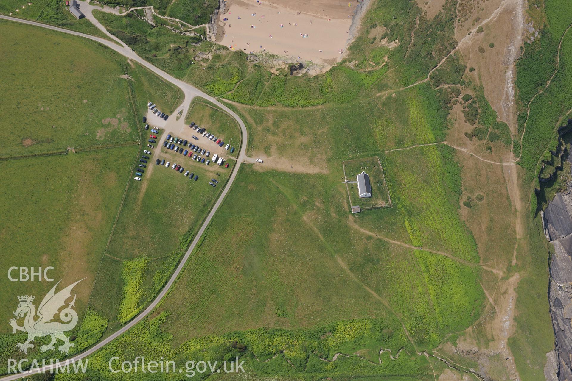 Holy Cross Church and the landing place on Traeth Mwnt, north of Cardigan. Oblique aerial photograph taken during the Royal Commission?s programme of archaeological aerial reconnaissance by Toby Driver on 12th July 2013.