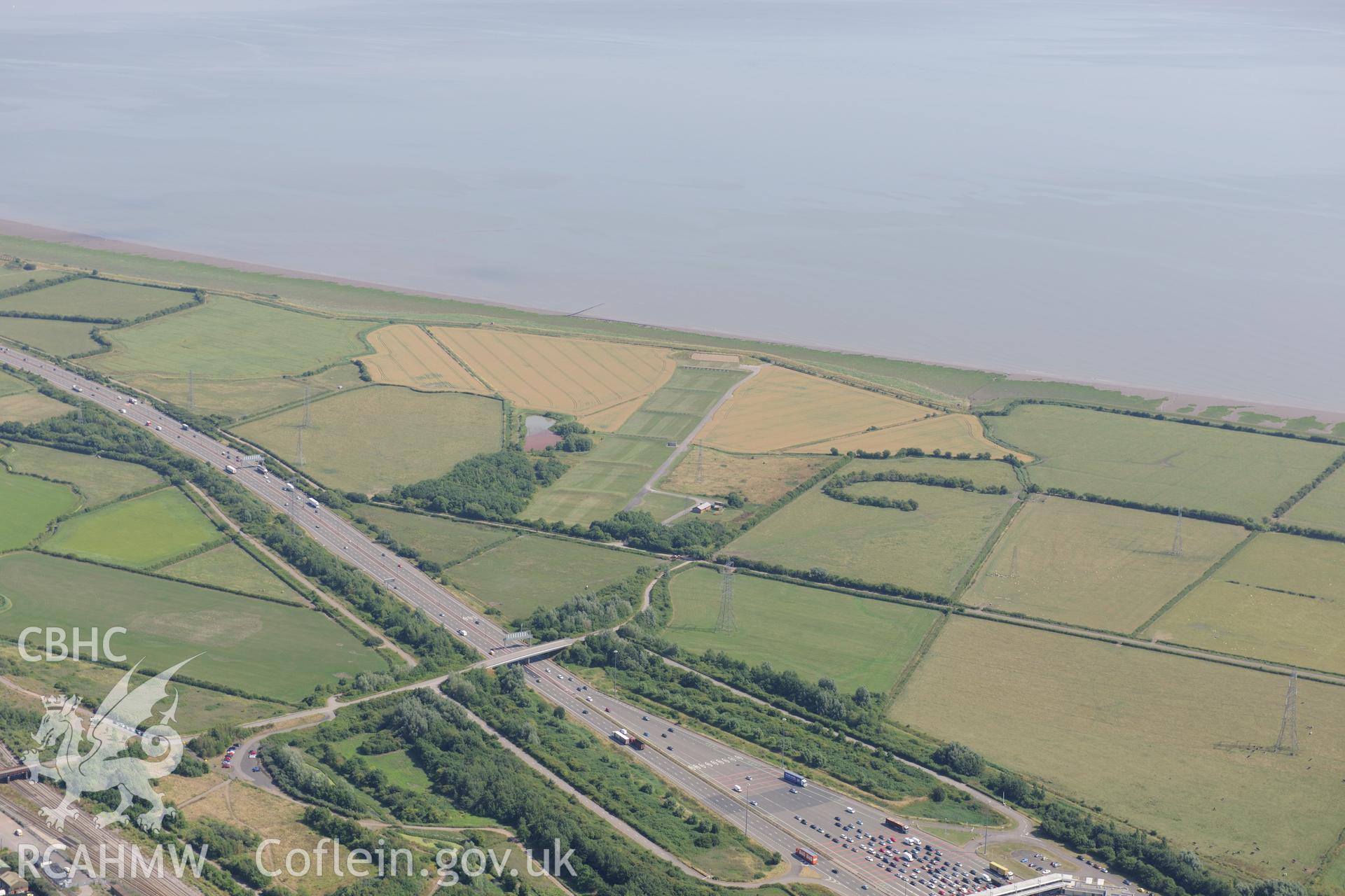 Rogiet Rifle range & section of the M4 motorway running along southern edge of Caldicot, on its way to the Second Severn Crossing. Oblique aerial photograph taken during RCAHMW?s programme of archaeological aerial reconnaissance by Toby Driver, 1 Aug 2013.