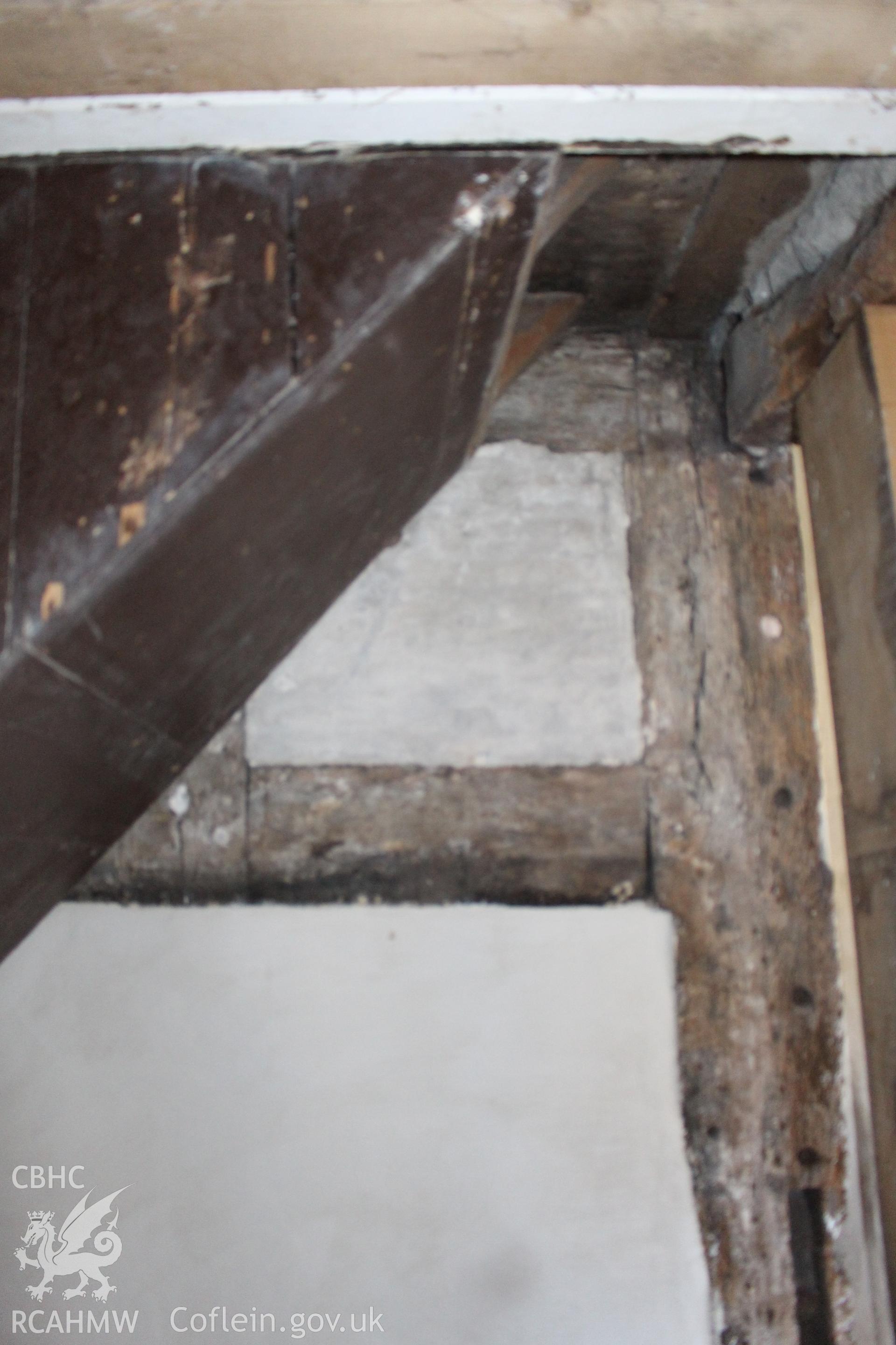 Colour photograph showing interior view of timber frame and plastered wall at Porth y Dwr, Clwyd Street, Ruthin. Photograph taken during survey conducted by Geoff Ward on 9th October 2014.