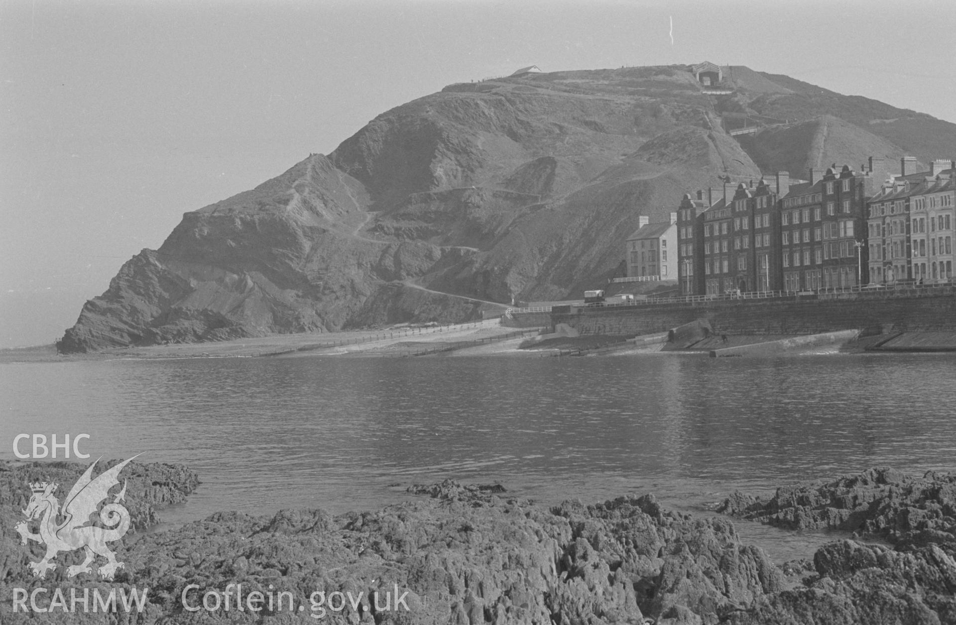 Digital copy of black & white negative showing Constitution Hill, Cliff Railway, Craiglas house and Alexandra Hall, Aberystwyth. Photograph by Arthur O. Chater, 9th April 1968 looking north from the rocks opposite the Queen's Hotel at Grid Ref SN 583 822.