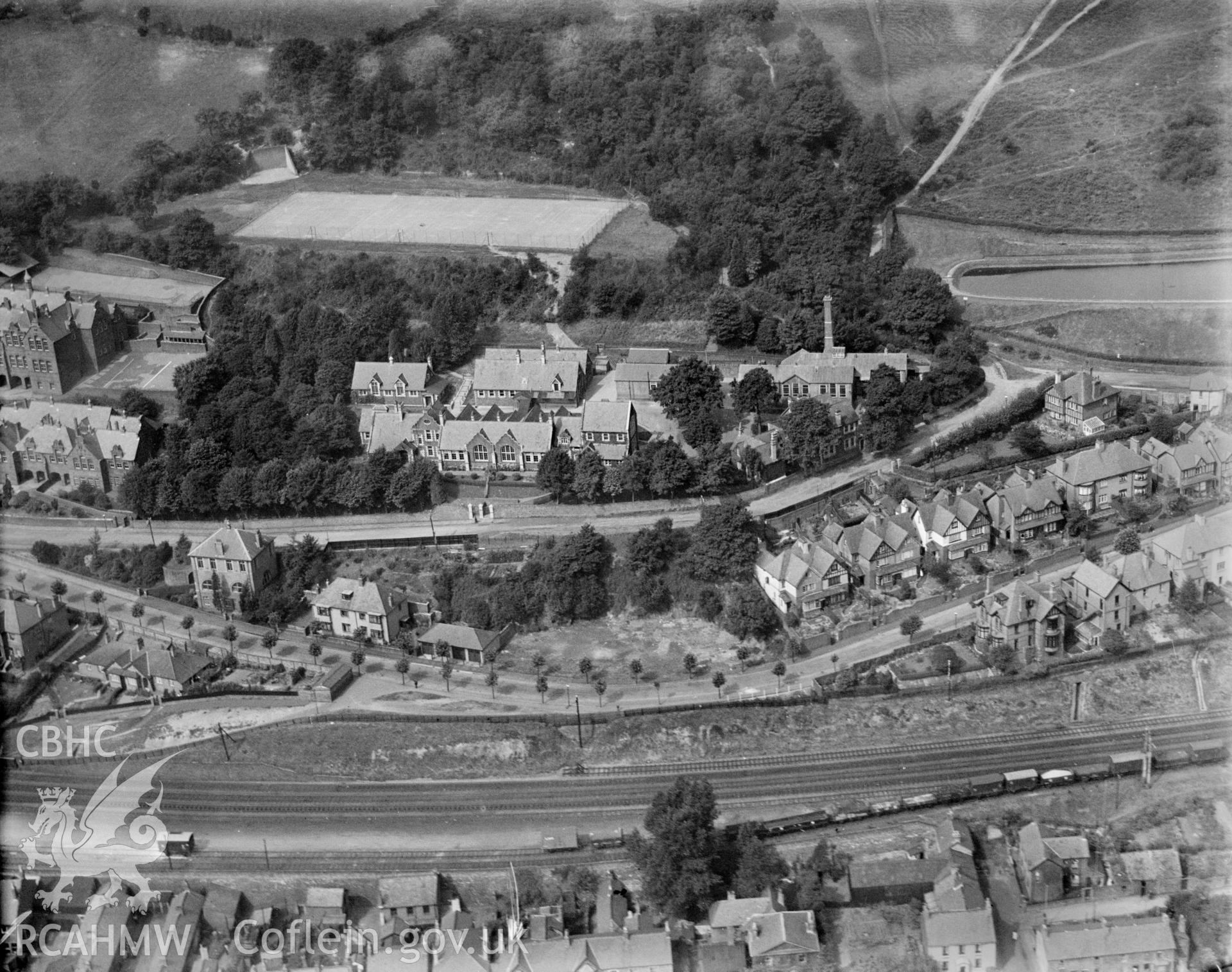 View of Pontypridd showing Grammar school, handball court, tennis courts and Lan Wood reservoir, oblique aerial view. 5?x4? black and white glass plate negative.