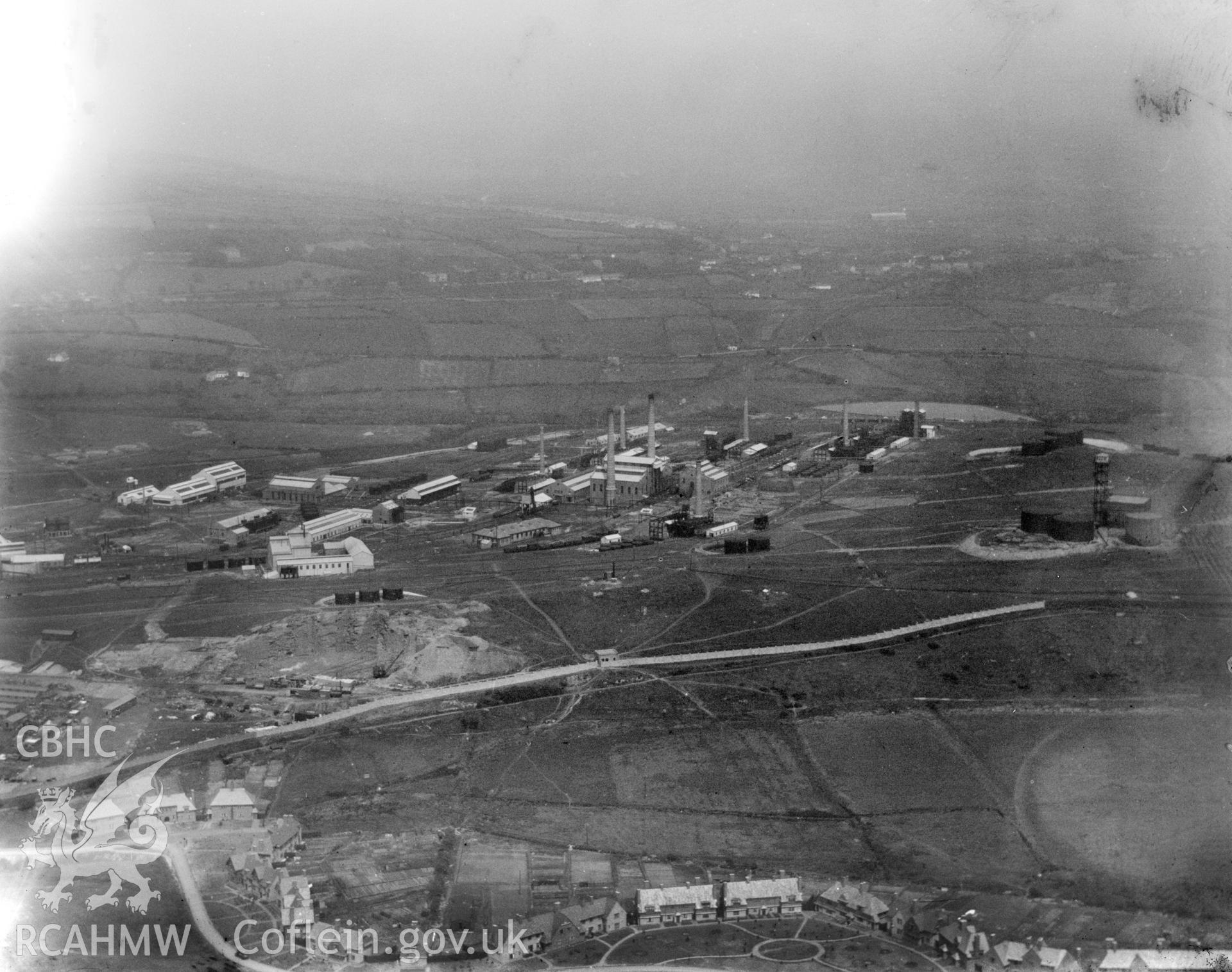 General view of the Anglo Iranian oil refinery, showing Llandarcy village in the foreground. Oblique aerial photograph, 5?x4? BW glass plate.