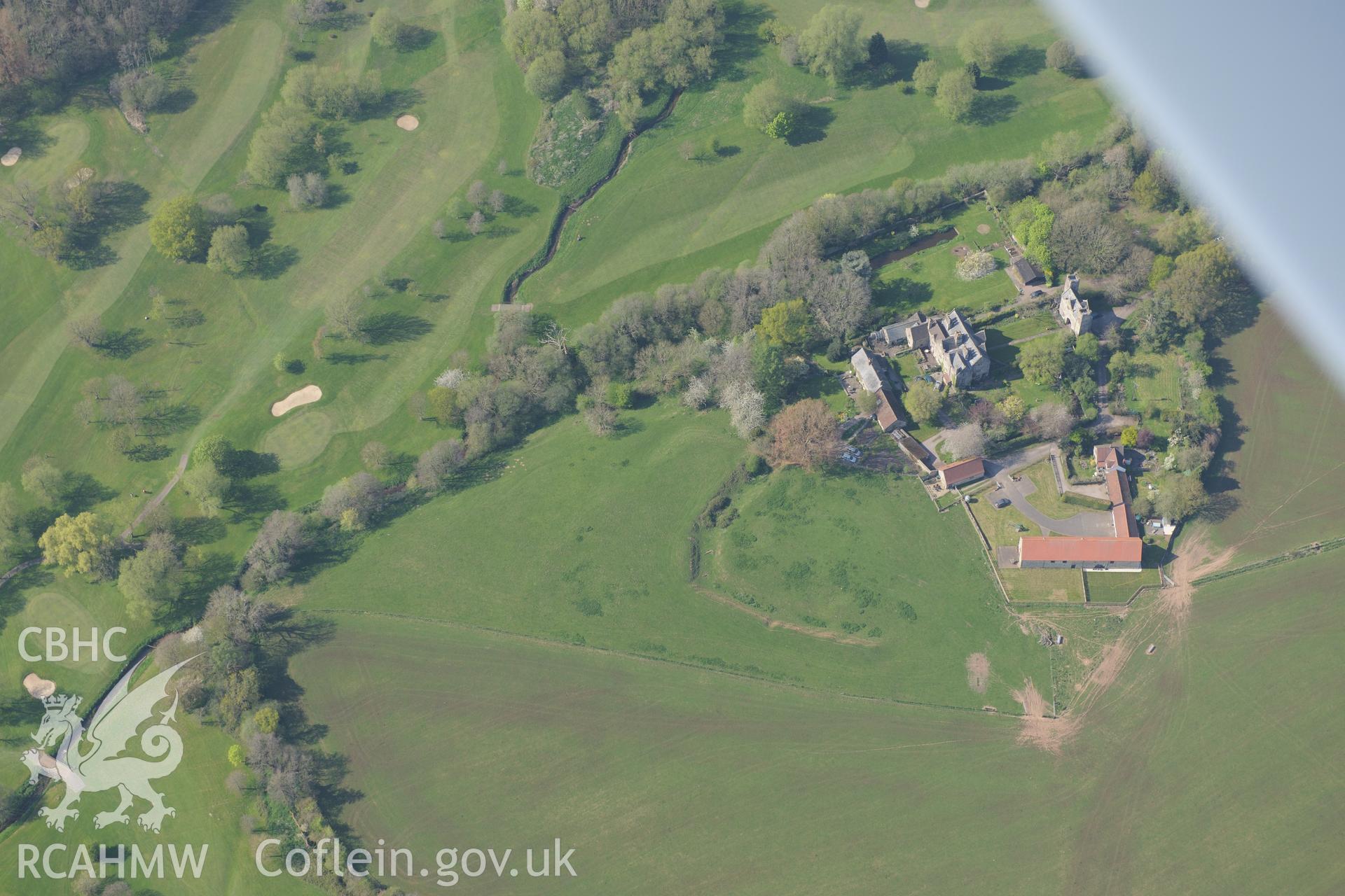 The Moat House, Moynes Court, Court Moat, Court Barns, Court Gatehouse and Moated site south of Moynes Court. Oblique aerial photograph taken during the Royal Commission?s programme of archaeological aerial reconnaissance by Toby Driver on 21st April 2015