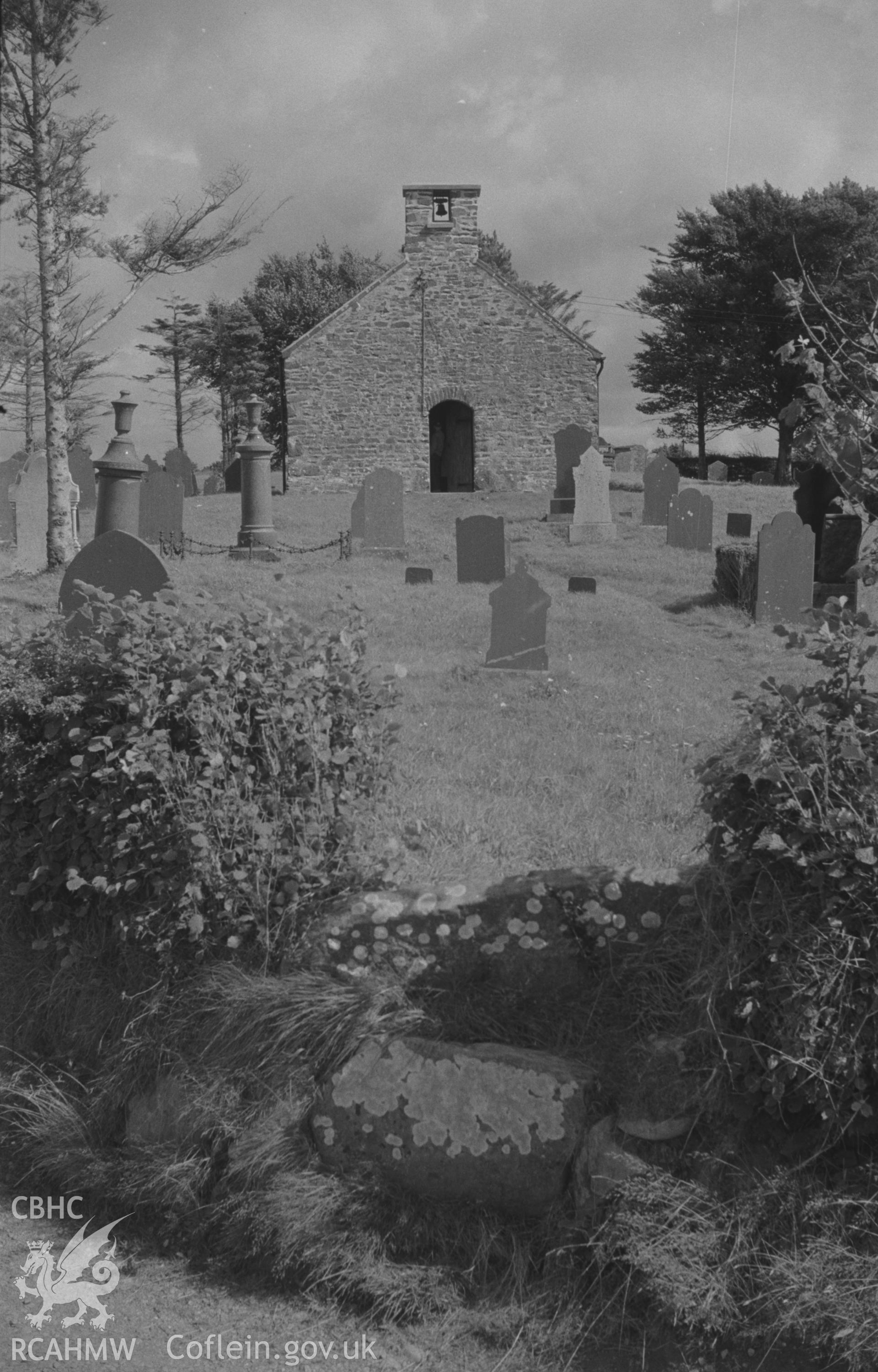 Digital copy of black & white negative showing view of St. Padarn's Church, Llanbadarn Odwyn, looking across the stile, from the lane, into the churchyard. Photographed by Arthur O. Chater on 2nd September 1967 looking east from Grid Reference SN 634 605.