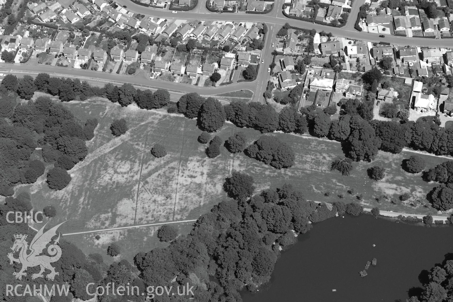 Acton Park and the barrow at Acton Park, with Wrexham beyond. Oblique aerial photograph taken during the Royal Commission's programme of archaeological aerial reconnaissance by Toby Driver on 30th June 2015.