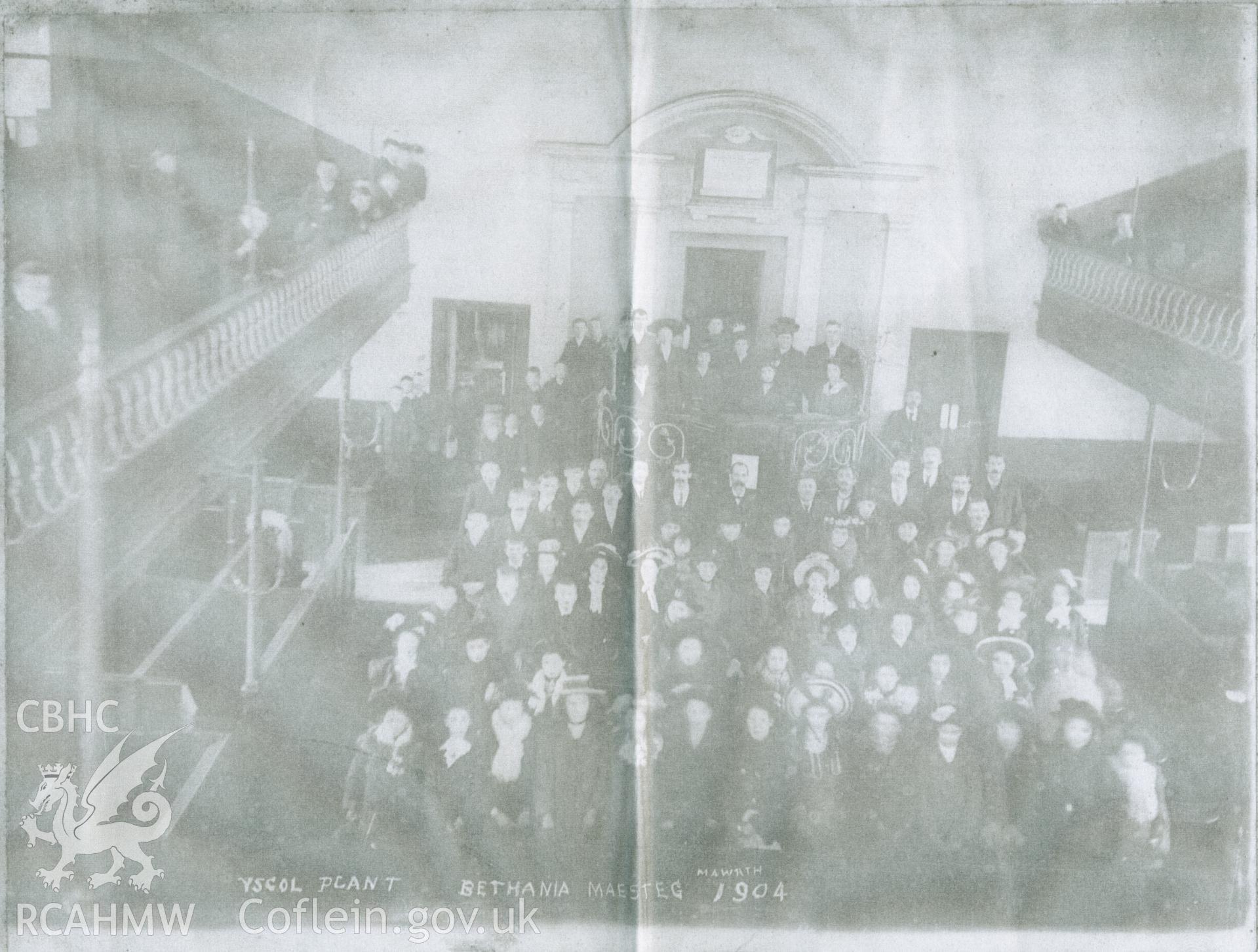 Black and white photograph of members of Ysgol Plant Bethania (Bethania Children's School), Maesteg, taken from the first floor balcony inside the chapel in March 1904. Donated to the RCAHMW by Cyril Philips as part of the Digital Dissent Project.