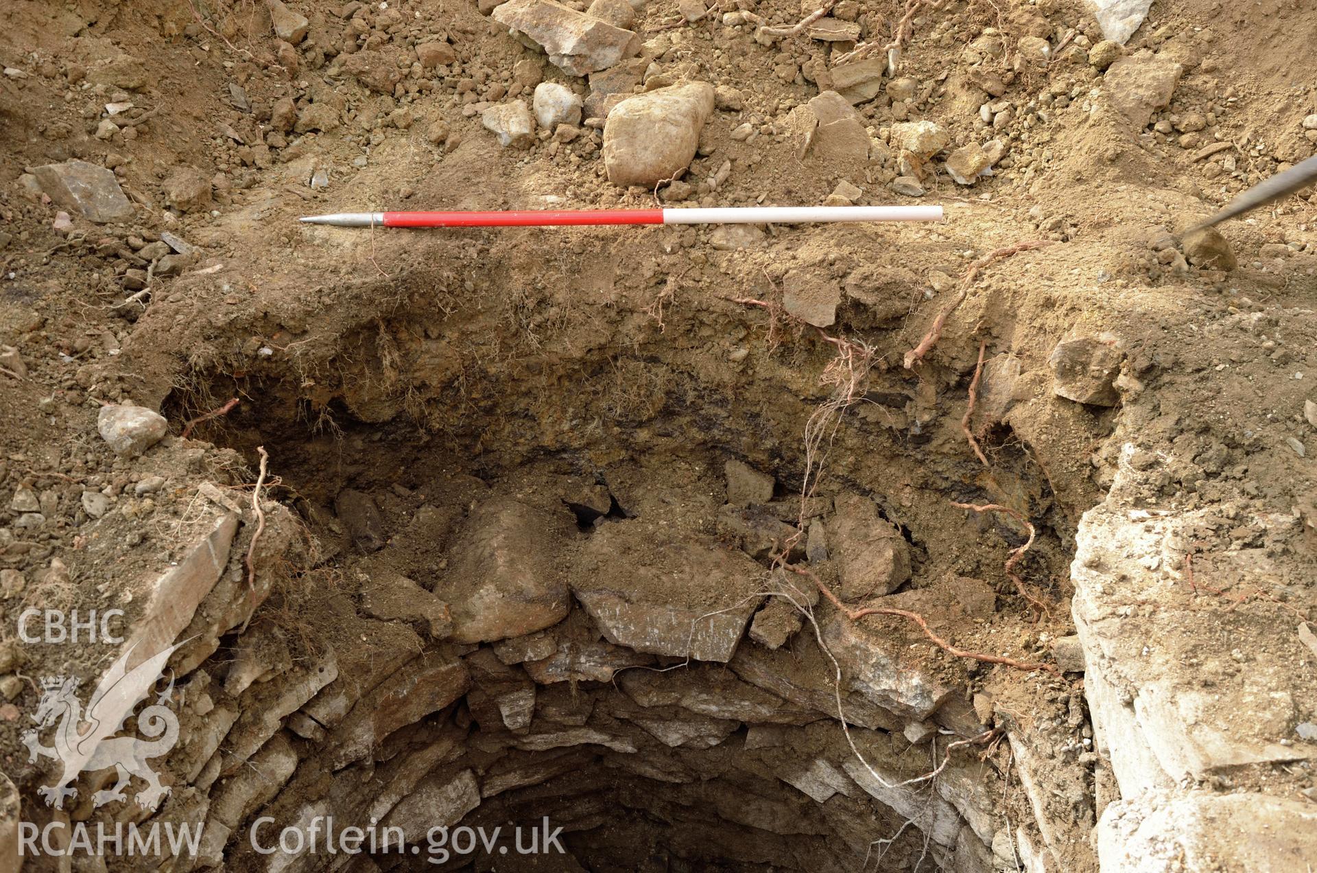 'Cut of well, after stone work part removed, view from north north west.' Photographed by Gwynedd Archaeological Trust as part of archaeological mitigation report for well at Plas Celynin, Henryd, Conwy, on 6th August 2018. Project no. G2568.