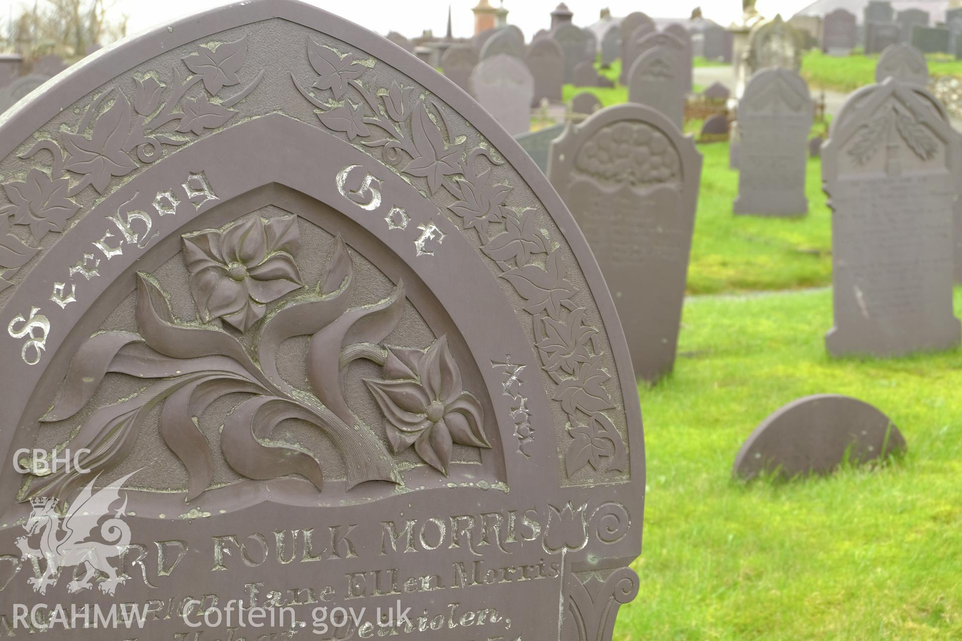 Colour photograph showing view looking at detail of slate headstone at Deiniolen Cemetery, produced by Richard Hayman 7th March 2017