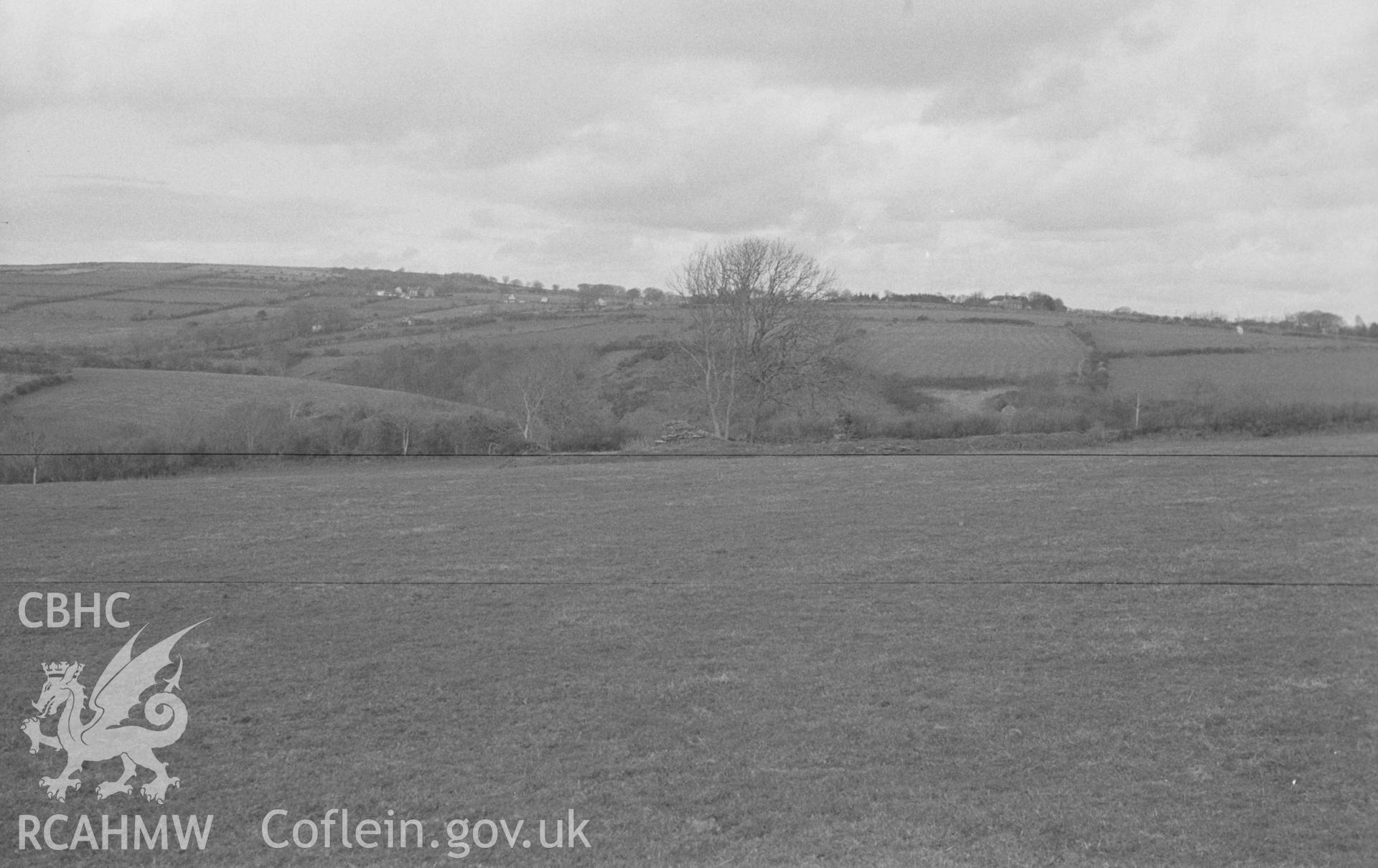 Digital copy of a black and white negative showing the Norman motte 100m north east of the site of St Mary's church, Llanfair Trefhelygen. Photographed in April 1963 by Arthur O. Chater from Grid Reference SN 3438 4425, looking south south east.