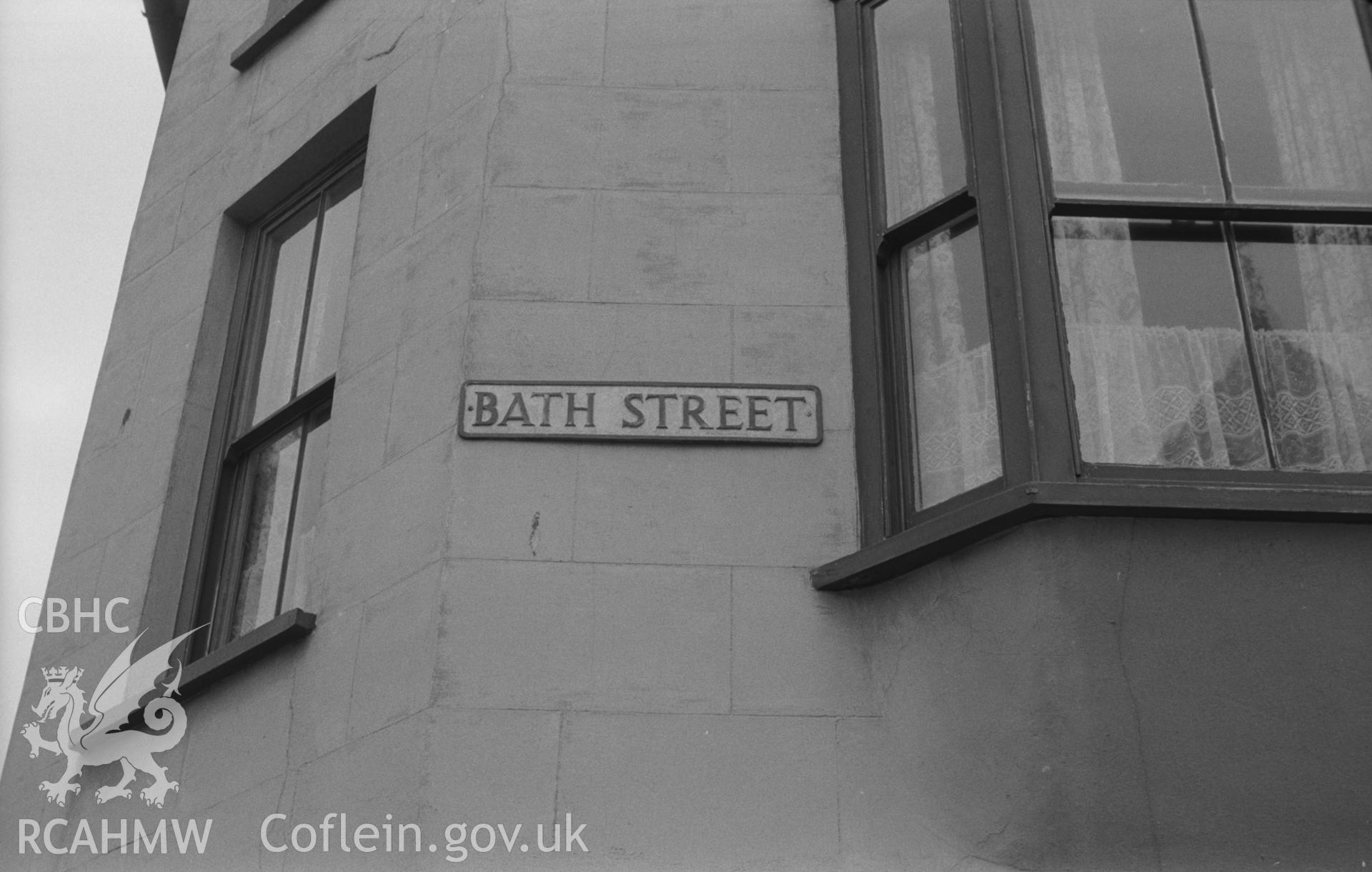 Digital copy of a black and white negative showing street name plaque on Bath Street, Aberystwyth. Photographed by Arthur O. Chater in September 1966.