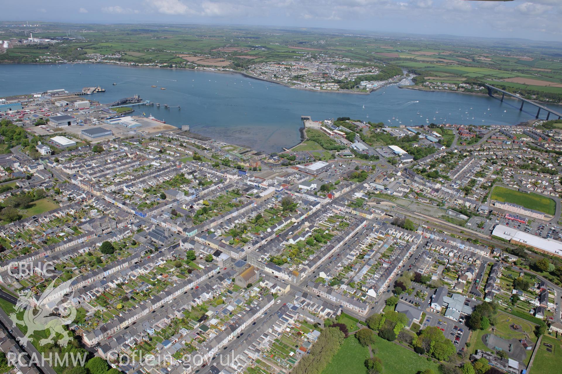 The town of Pembroke Dock, with the Cleddau Bridge leading to the town of Neyland in the distance. Oblique aerial photograph taken during the Royal Commission's programme of archaeological aerial reconnaissance by Toby Driver on 13th May 2015.