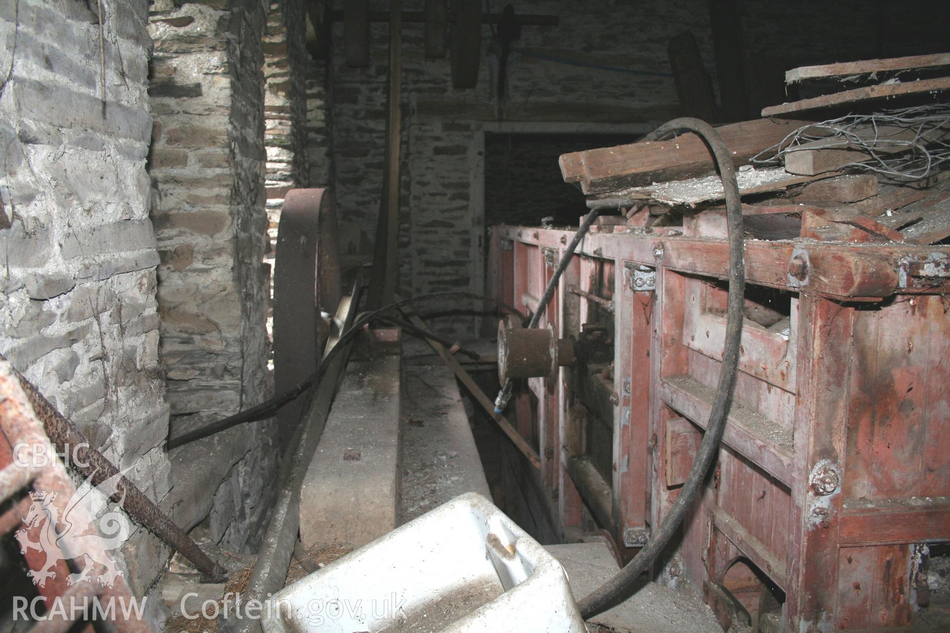 Interior view of threshing house showing threshing machine. Photographic survey of the threshing machine in the threshing house at Tan-y-Graig Farm, Llanfarian. Conducted by Geoff Ward and John Wiles 11th December 2016.