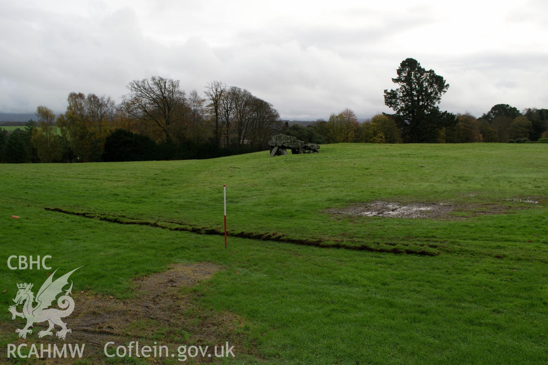 View from north west of 10m long wider trench, showing relationship with burial chamber. Photographed during archaeological watching brief of Plas Newydd, Ynys Mon, conducted by Gwynedd Archaeological Trust on 14th November 2017. Project no. 2542.