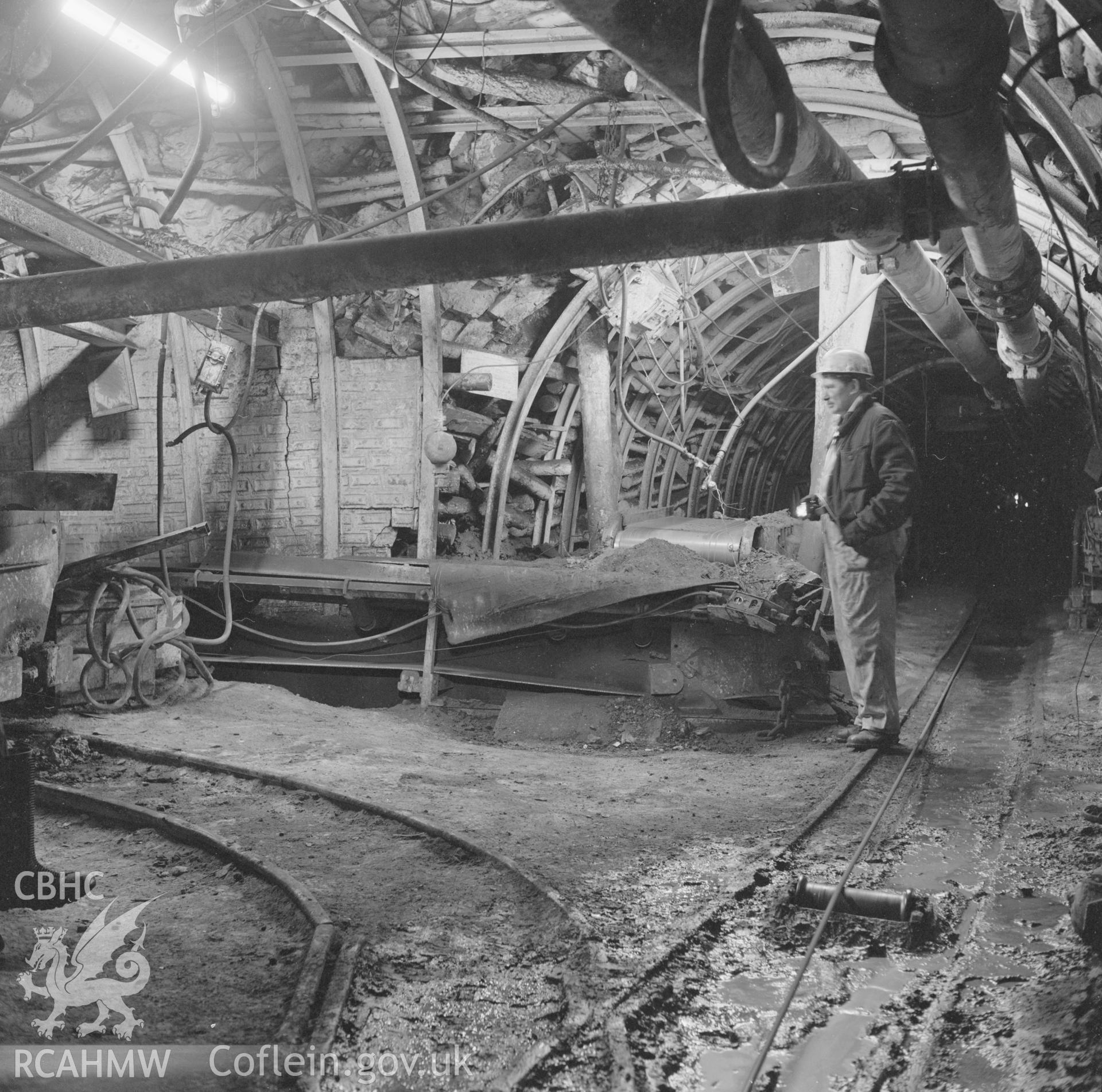 Digital copy of an acetate negative showing transfer point attendant with tram of supplies on haulage system at Marine Colliery, from the John Cornwell Collection.