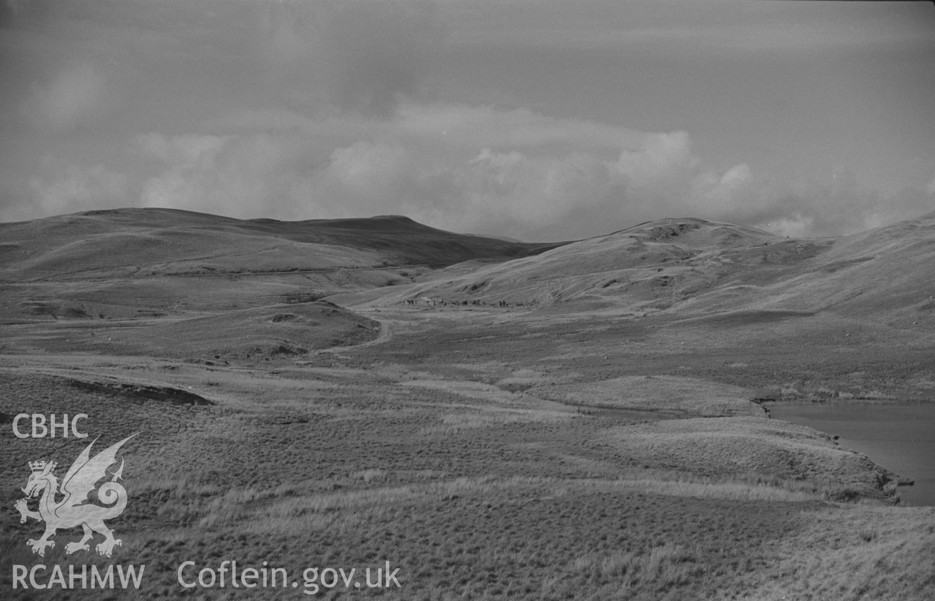 Digital copy of a black and white negative showing view from road by Waen Hesgog to long ruined building 500m south west of Esgair-Hir mine. Photographed by Arthur O. Chater on 29th August 1967 looking north from Grid Reference SN 728 903.