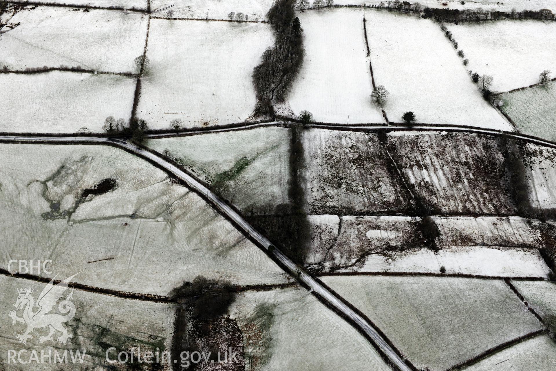 Earthworks of a Roman road, east of Porthyrhyd, north west of Llandovery. Oblique aerial photograph taken during the Royal Commission?s programme of archaeological aerial reconnaissance by Toby Driver on 15th January 2013.