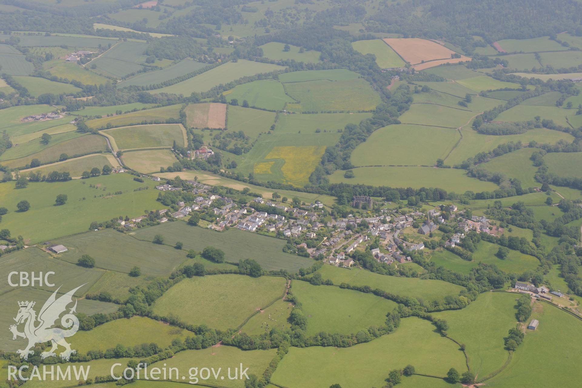 Grosmont village including views of the castle and St. Nicholas' church. Oblique aerial photograph taken during the Royal Commission's programme of archaeological aerial reconnaissance by Toby Driver on 11th June 2015.