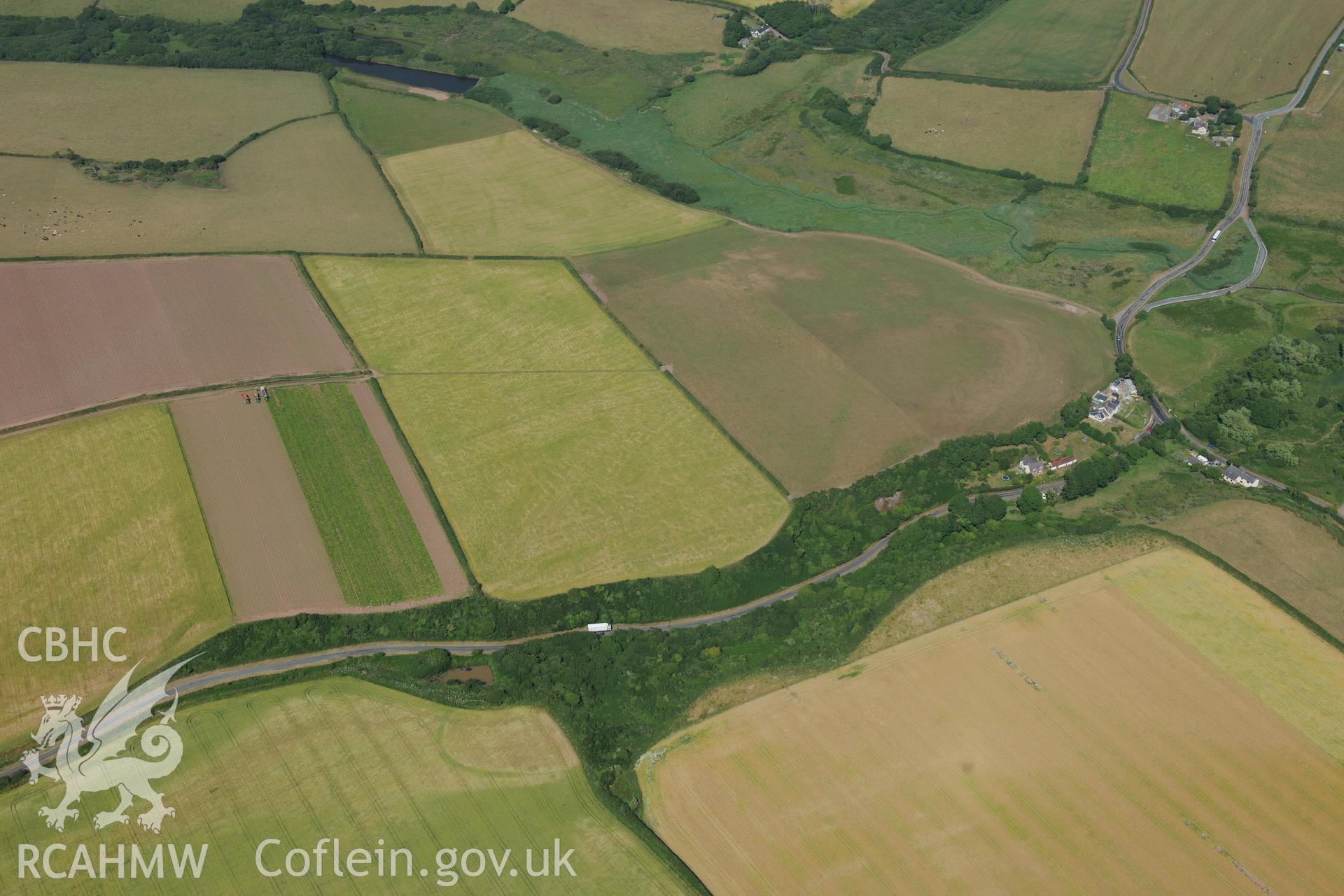 Mullock Bridge West Inland Promontory Fort and Circular Enclosure. Oblique aerial photograph taken during the Royal Commission?s programme of archaeological aerial reconnaissance by Toby Driver on 16th July 2013.